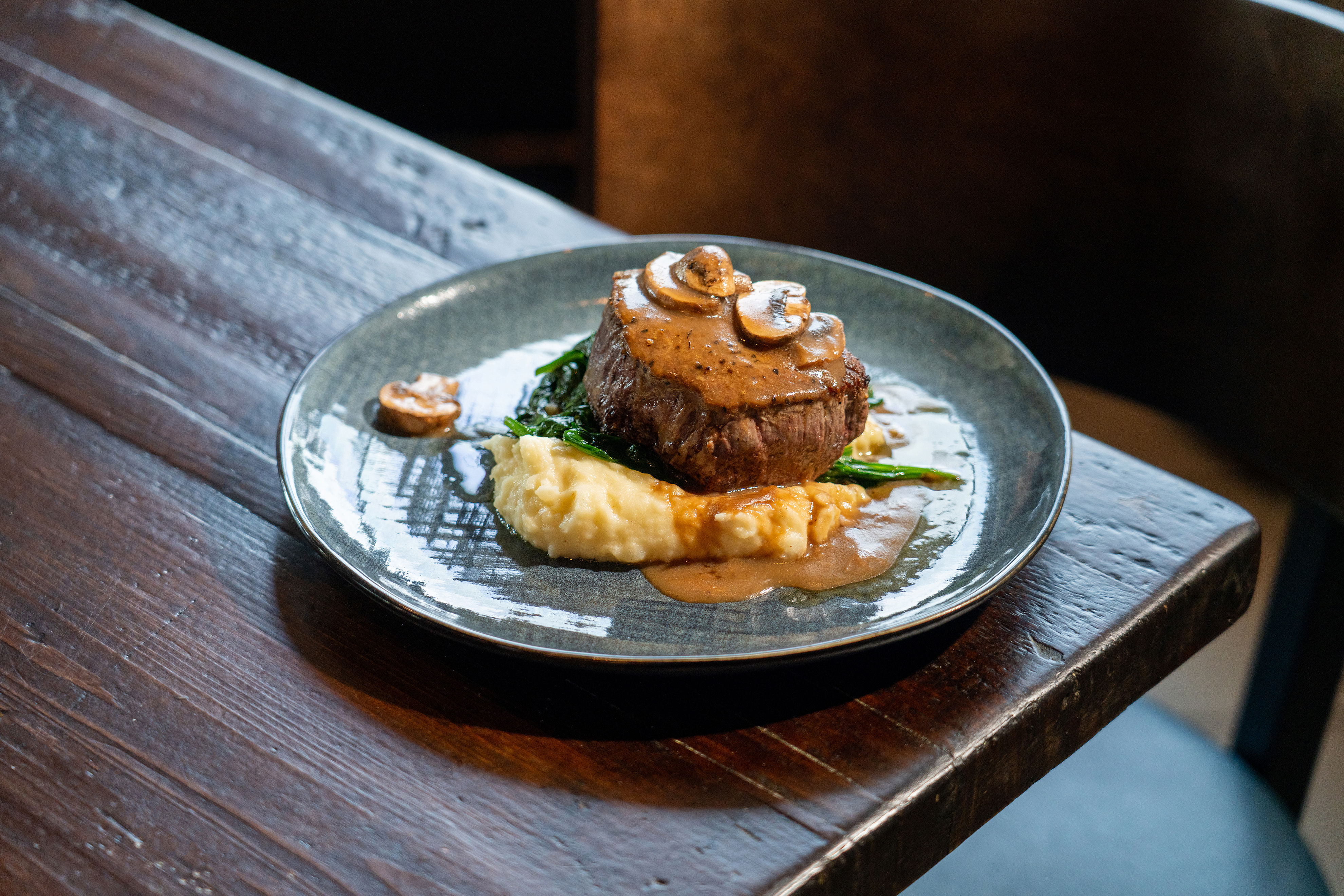 a plate of food sitting on top of a wooden table