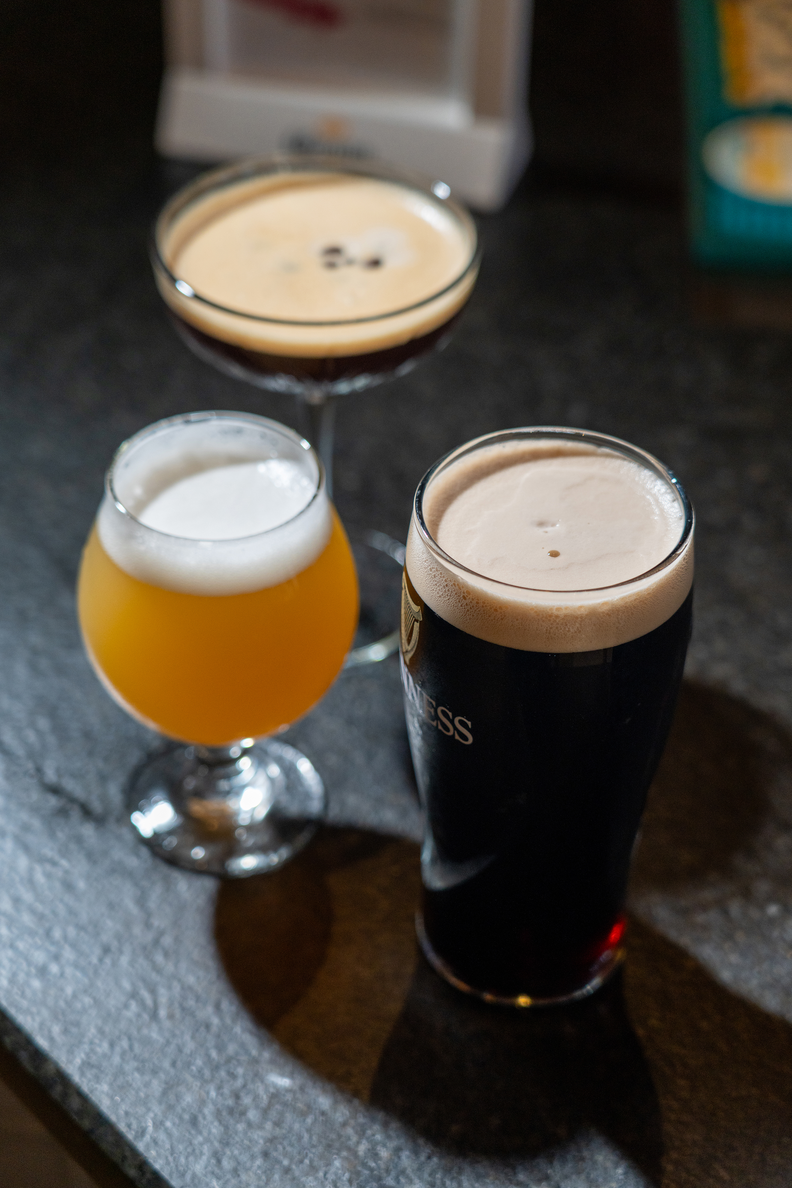 a cup of coffee and a glass of beer on a table