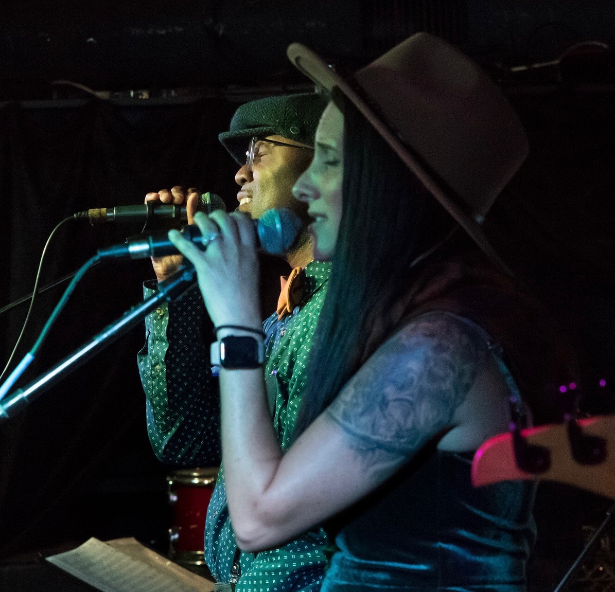 a man and woman singing into microphones