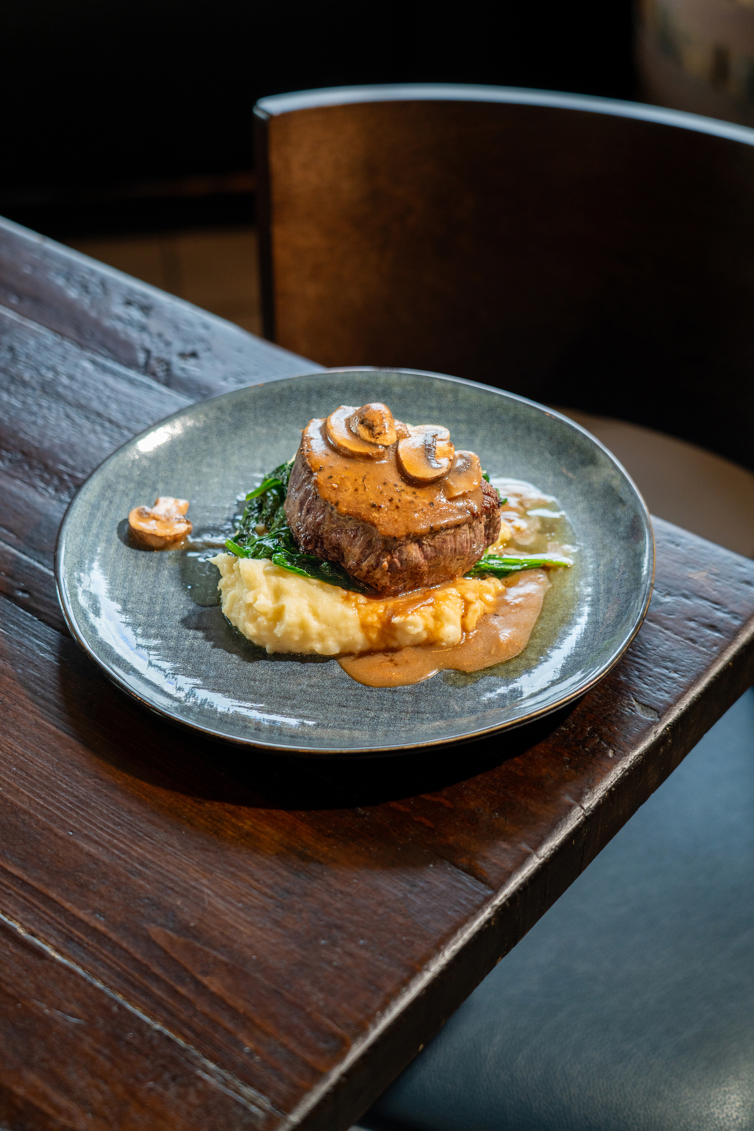 a plate of food sitting on top of a wooden table