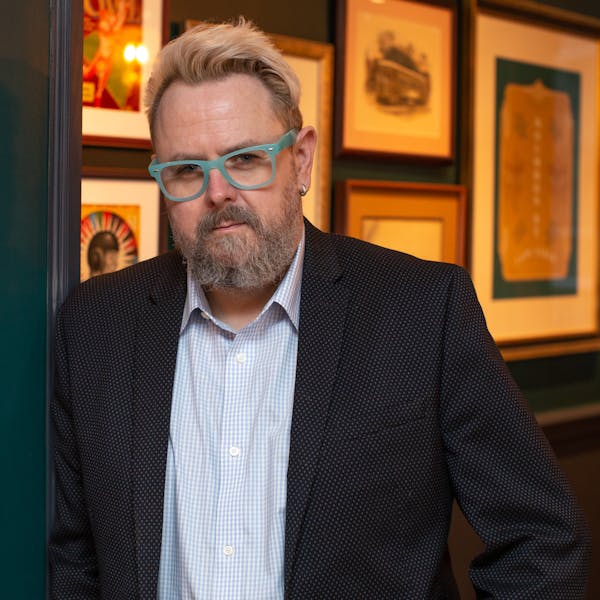 a man wearing glasses posing for the camera