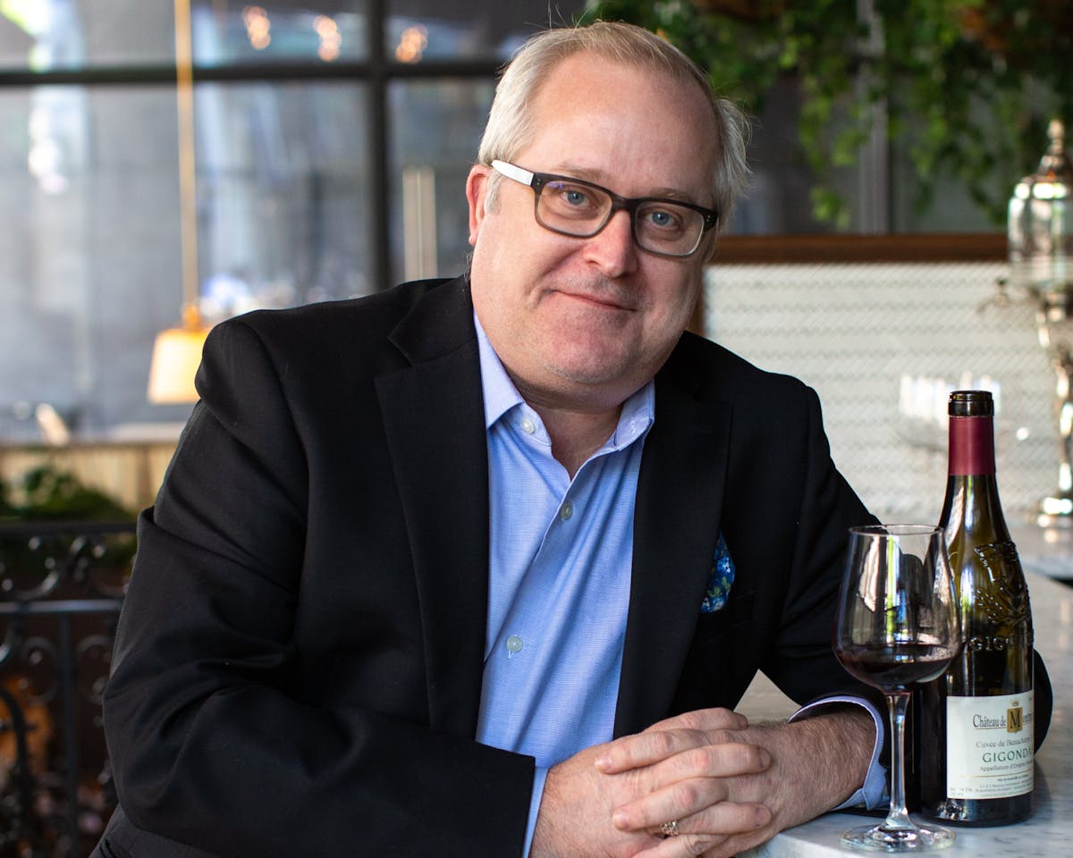 a man holding a glass of wine