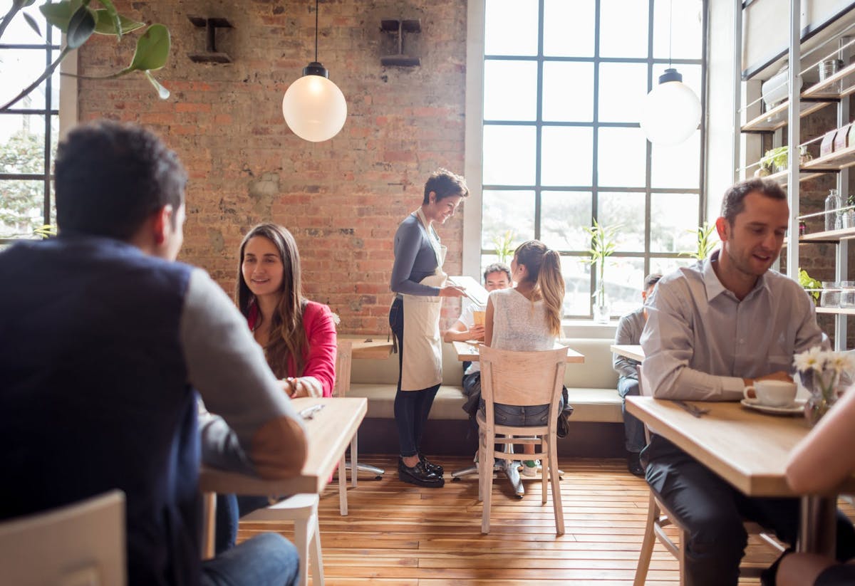 a group of people sitting at a restaurant