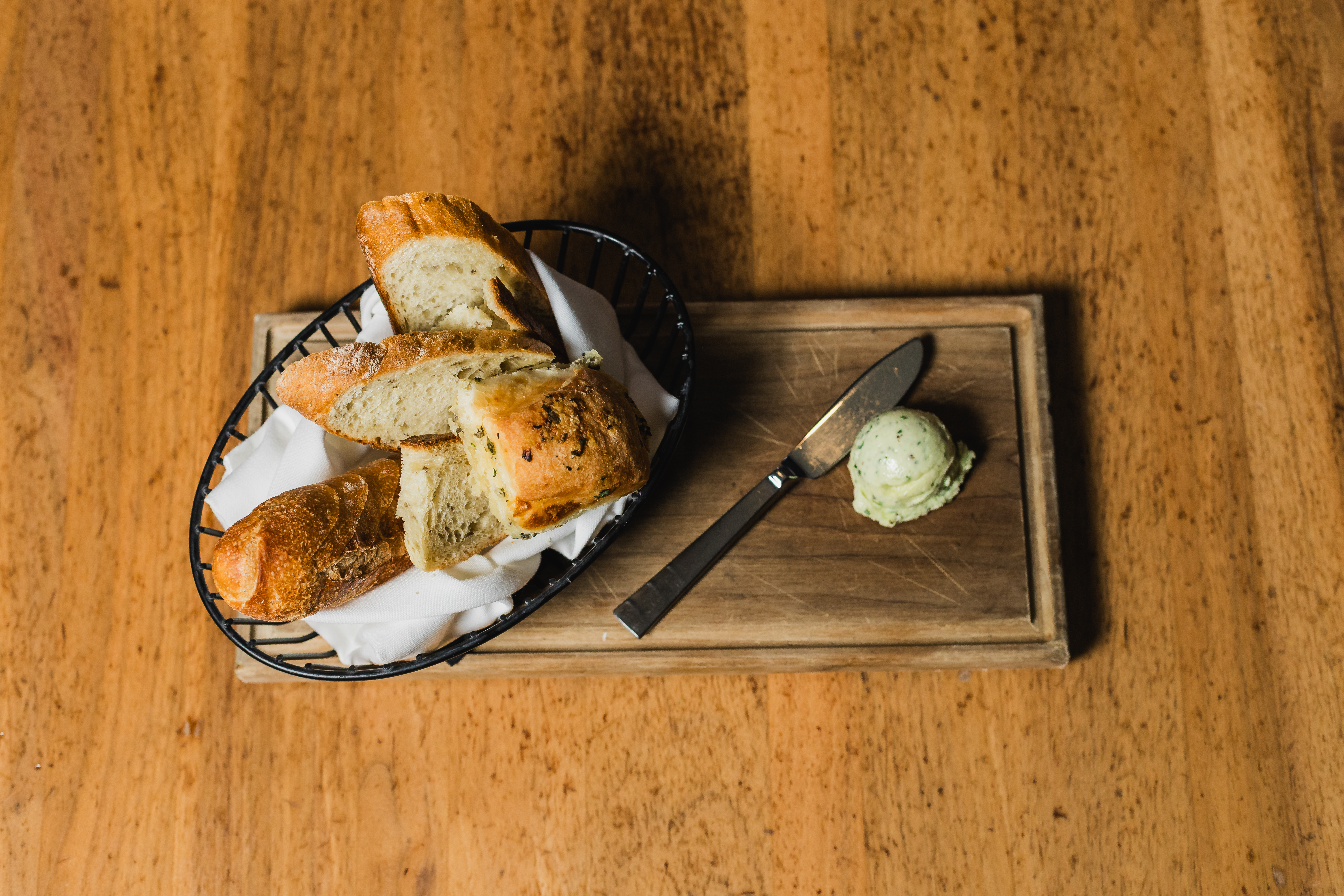 Loaf of bread sitting on top of a wooden cutting board