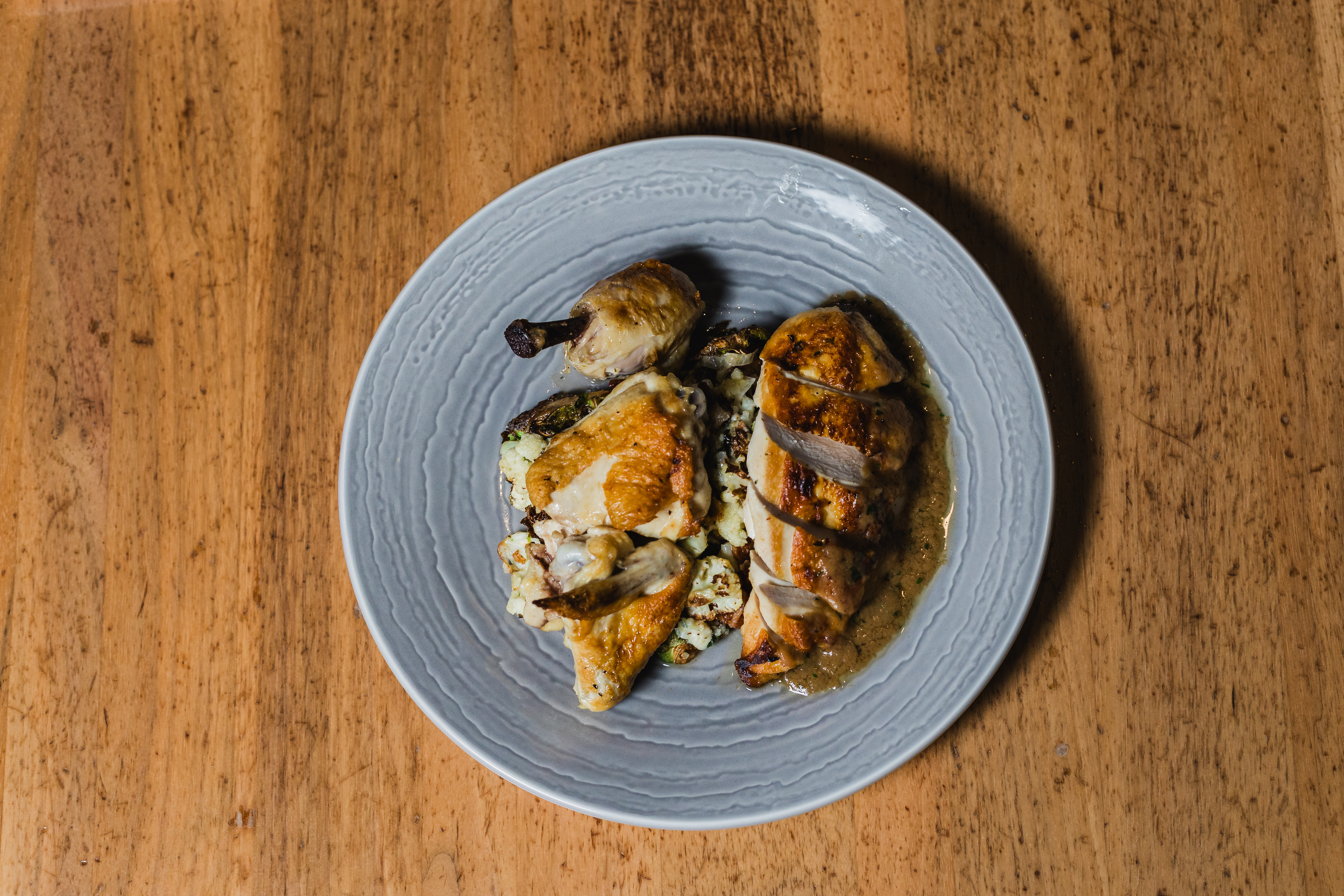 a plate of food sitting on top of a wooden table