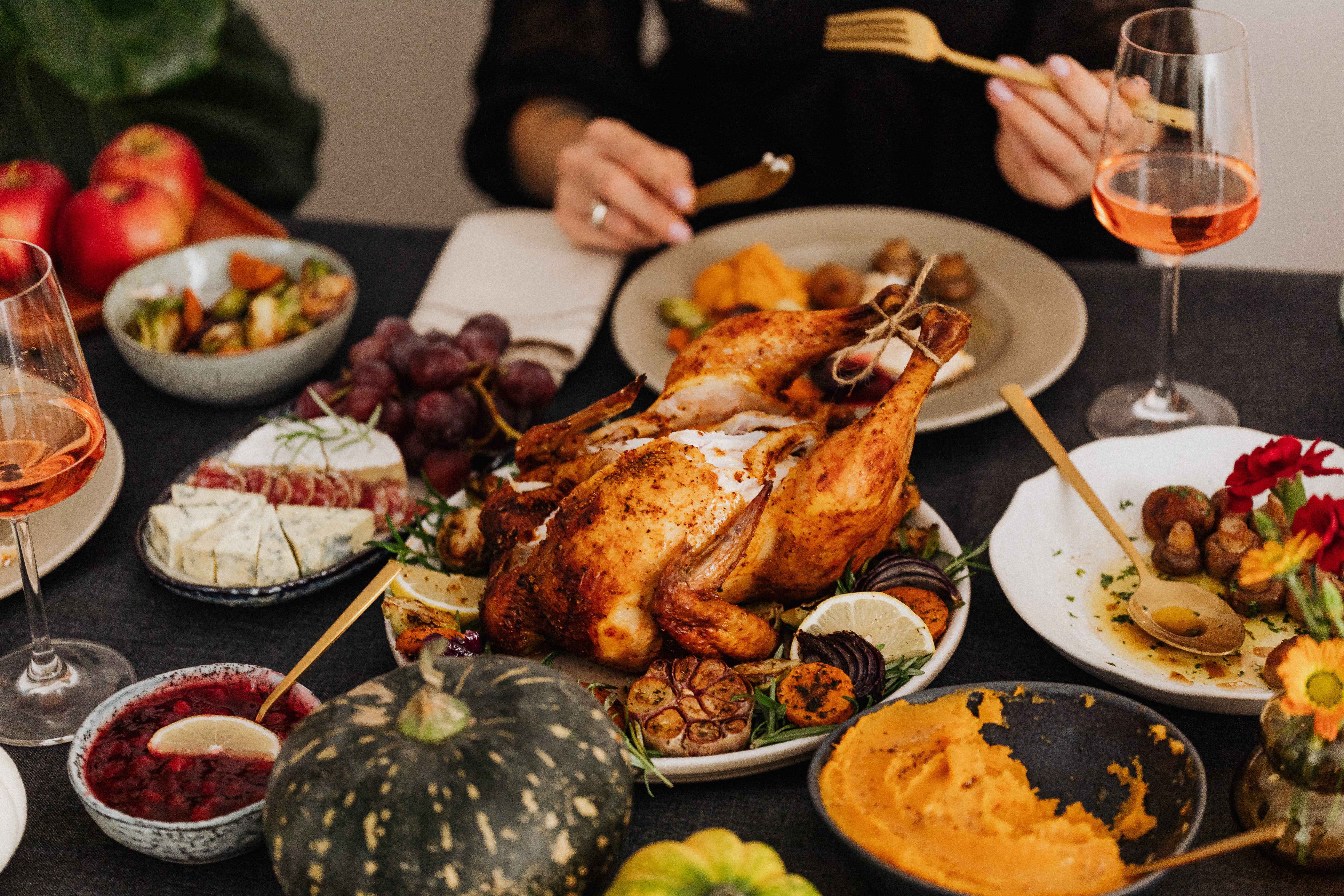 a group of people sitting at a table with a plate of food