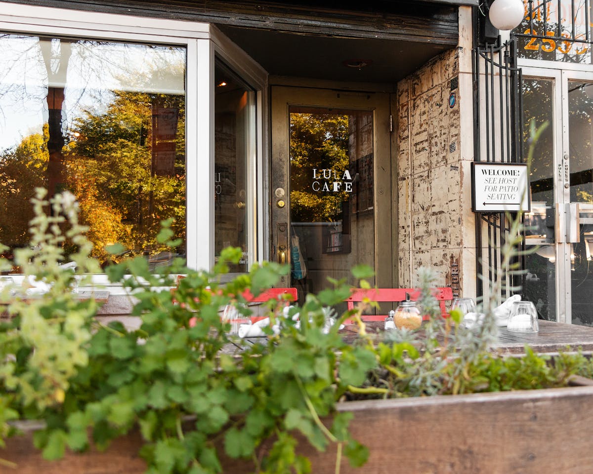 a vase of flowers sits in front of a building