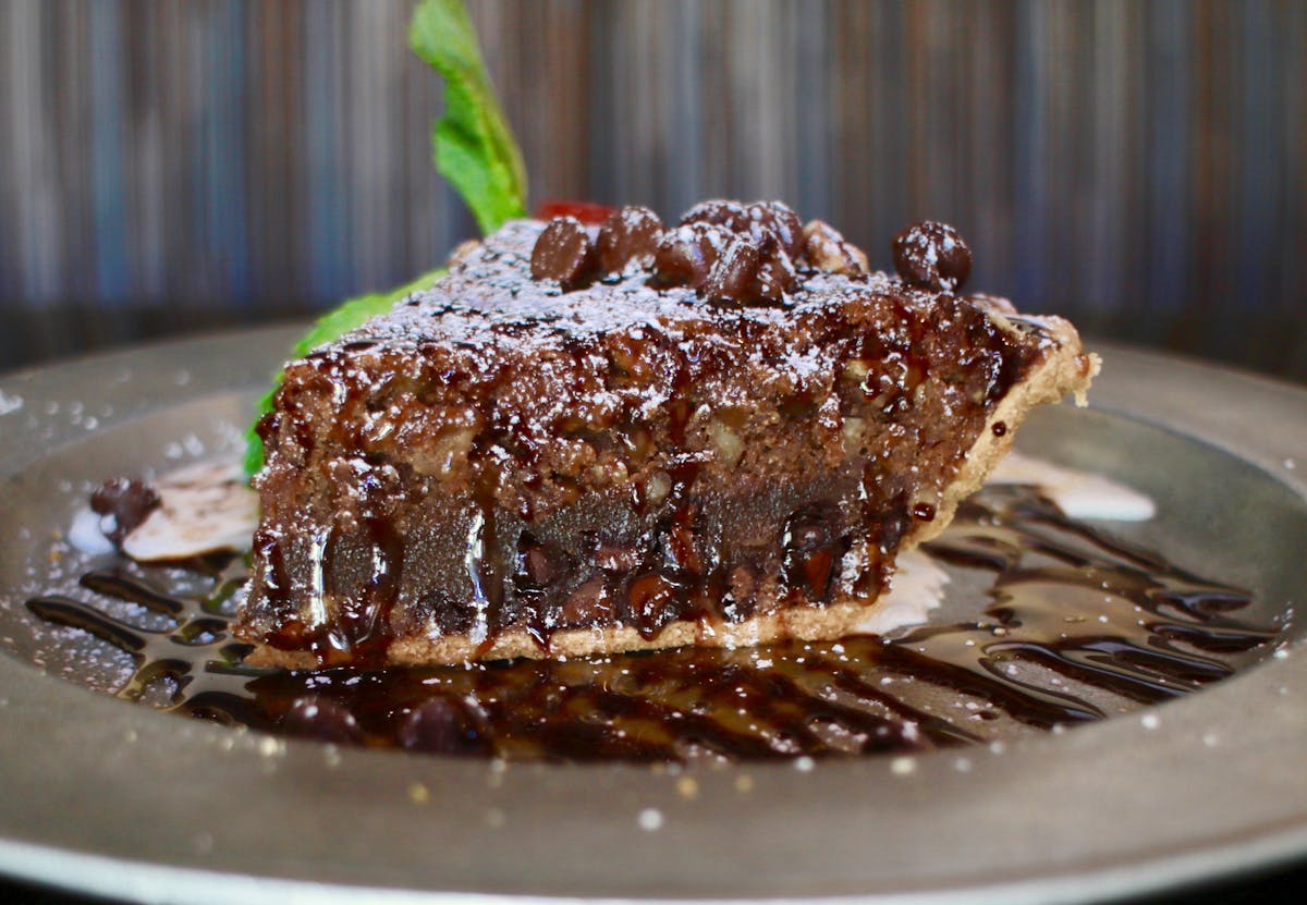 a close up of a slice of chocolate cake on a plate