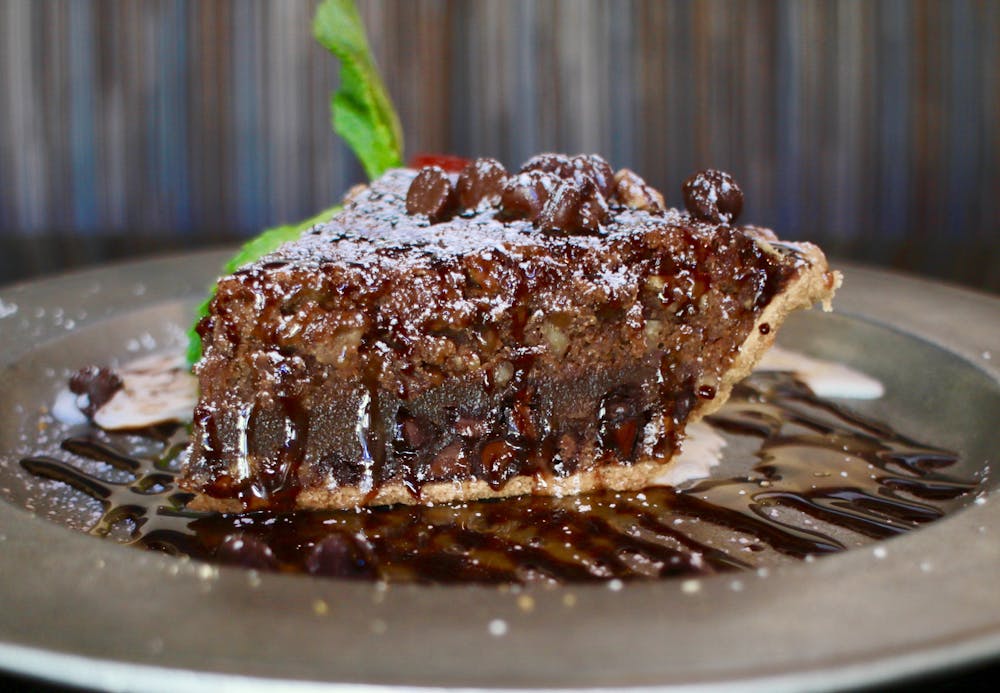 a close up of a slice of chocolate cake on a plate