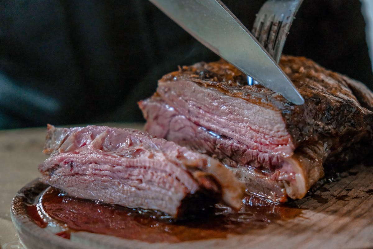 a close up of a steak being cut in half