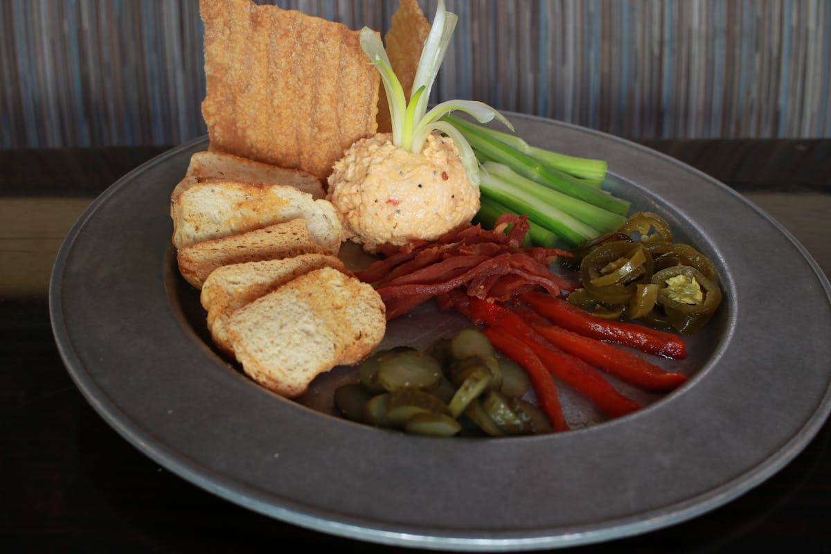 a plate of food containing red and green peppers