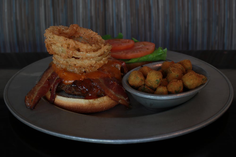 a plate with a sandwich sided by hash browns