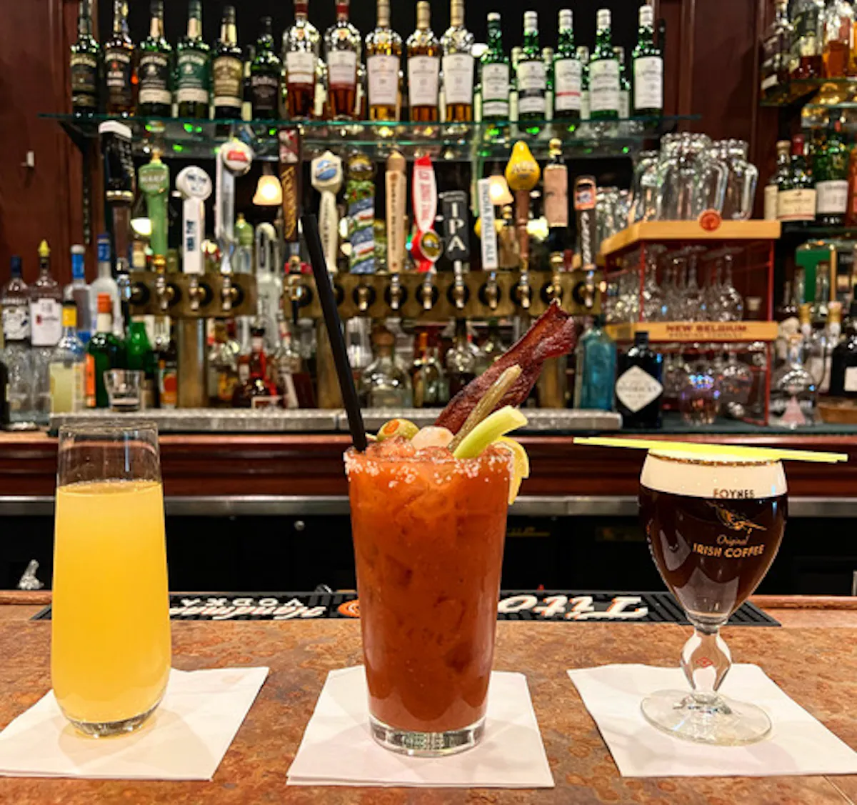 glasses of cocktails and beer on a table