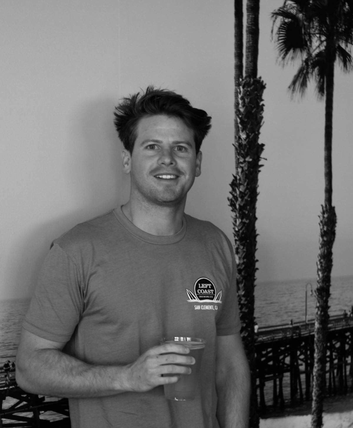 a man holding a bottle posing for the camera