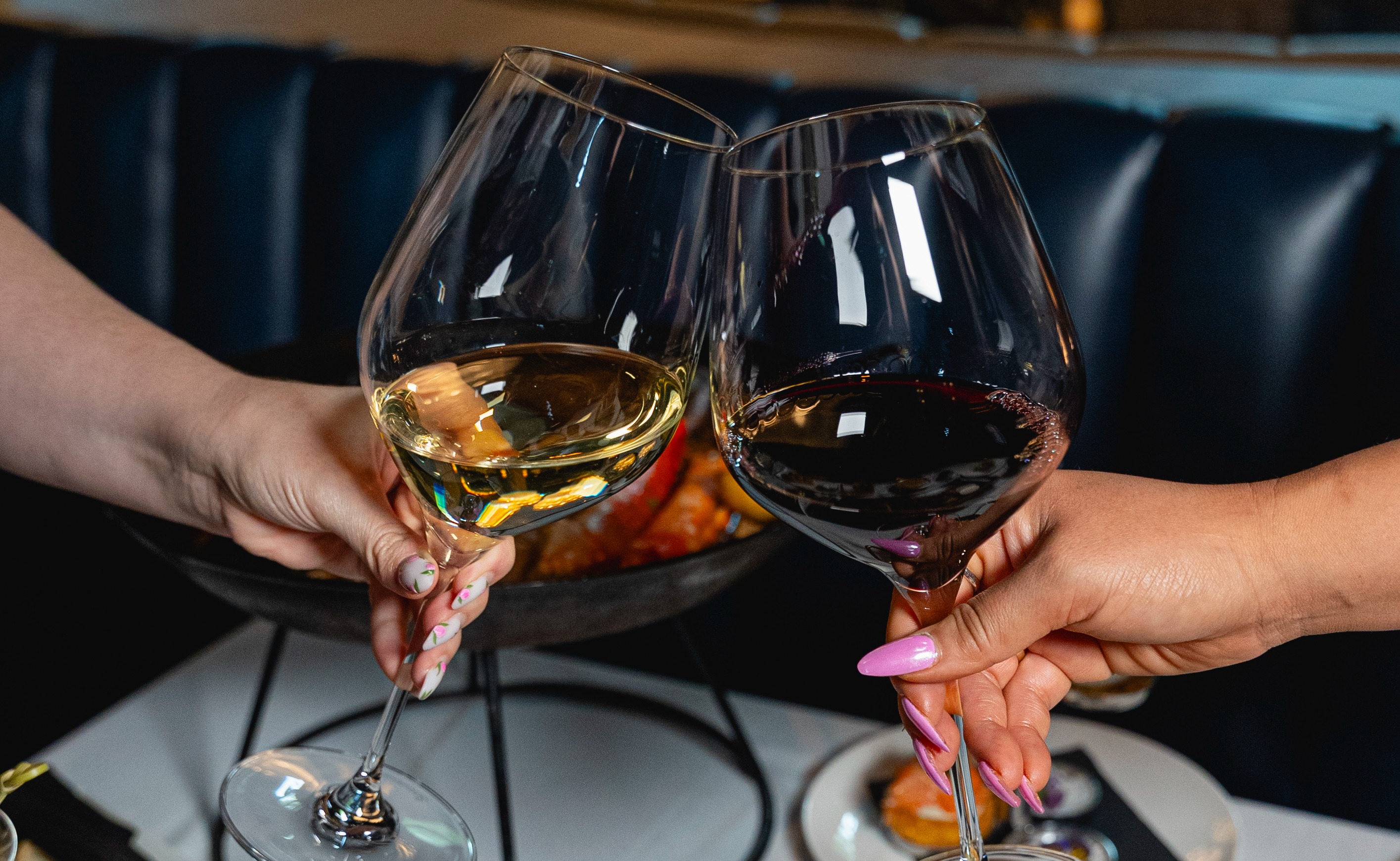 a hand holding a glass of wine