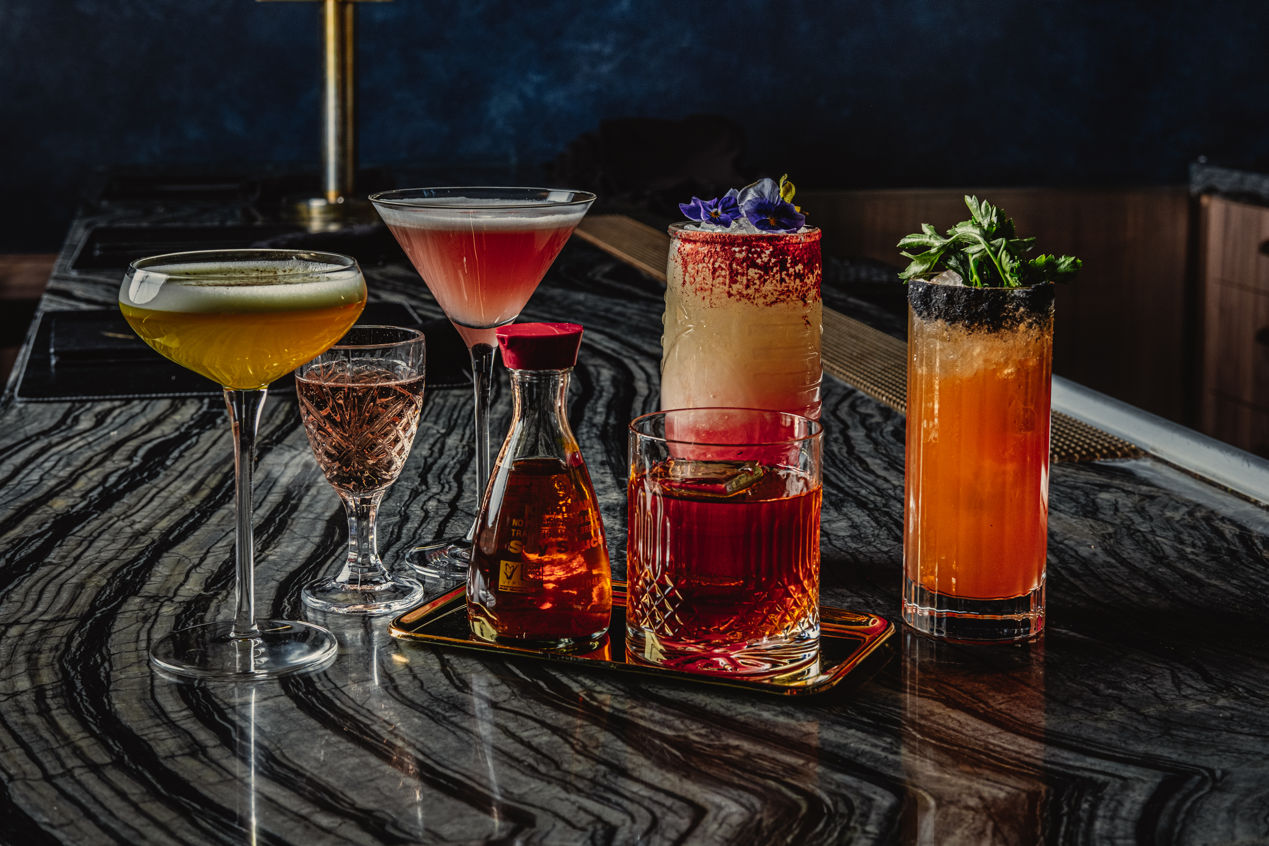 a group of different colored drinks on a table