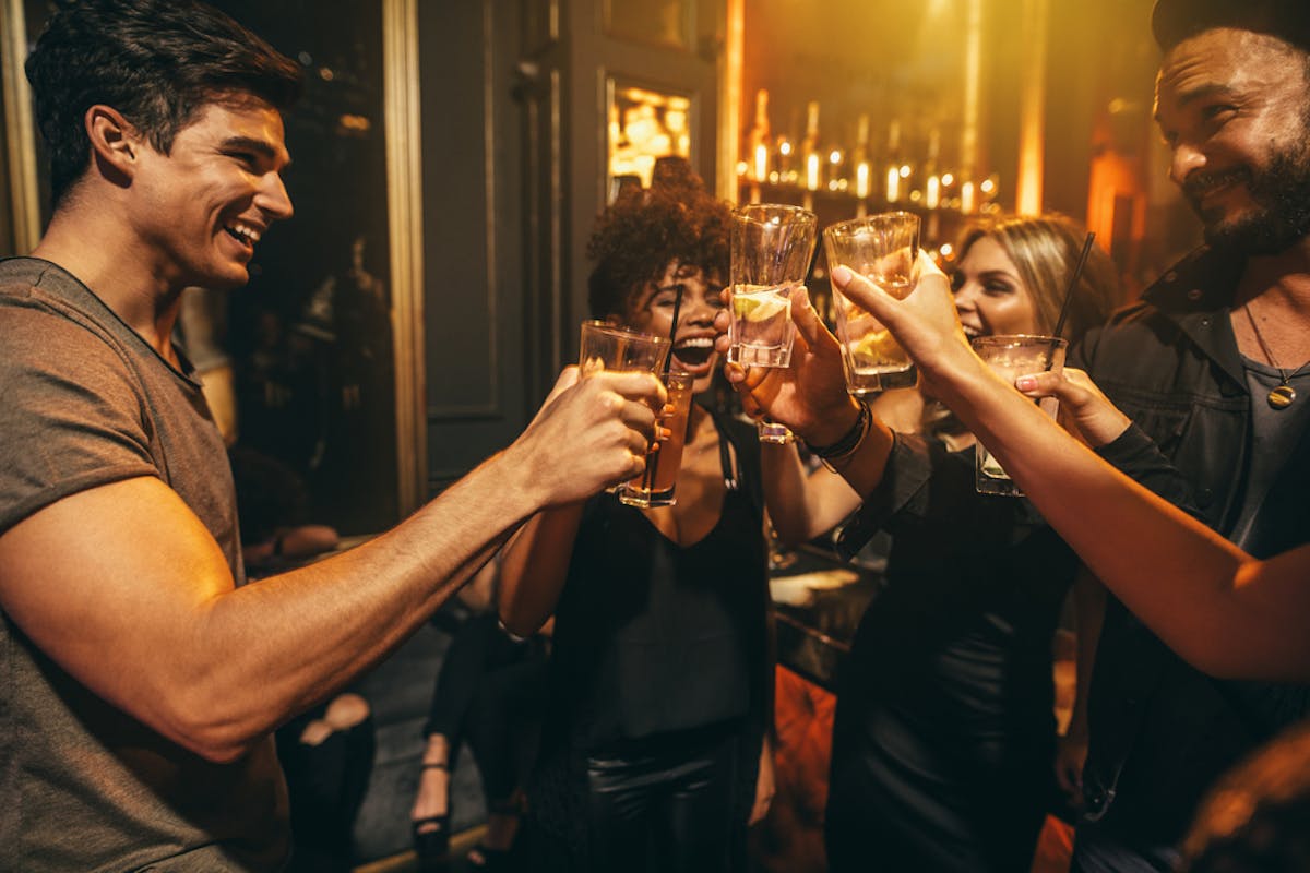 a group of people holding wine glasses