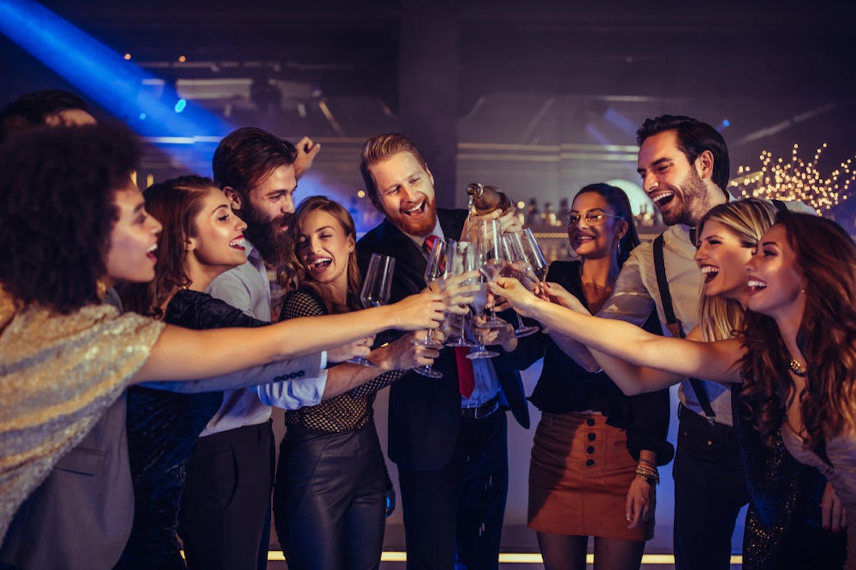 a group of people standing on a stage posing for the camera