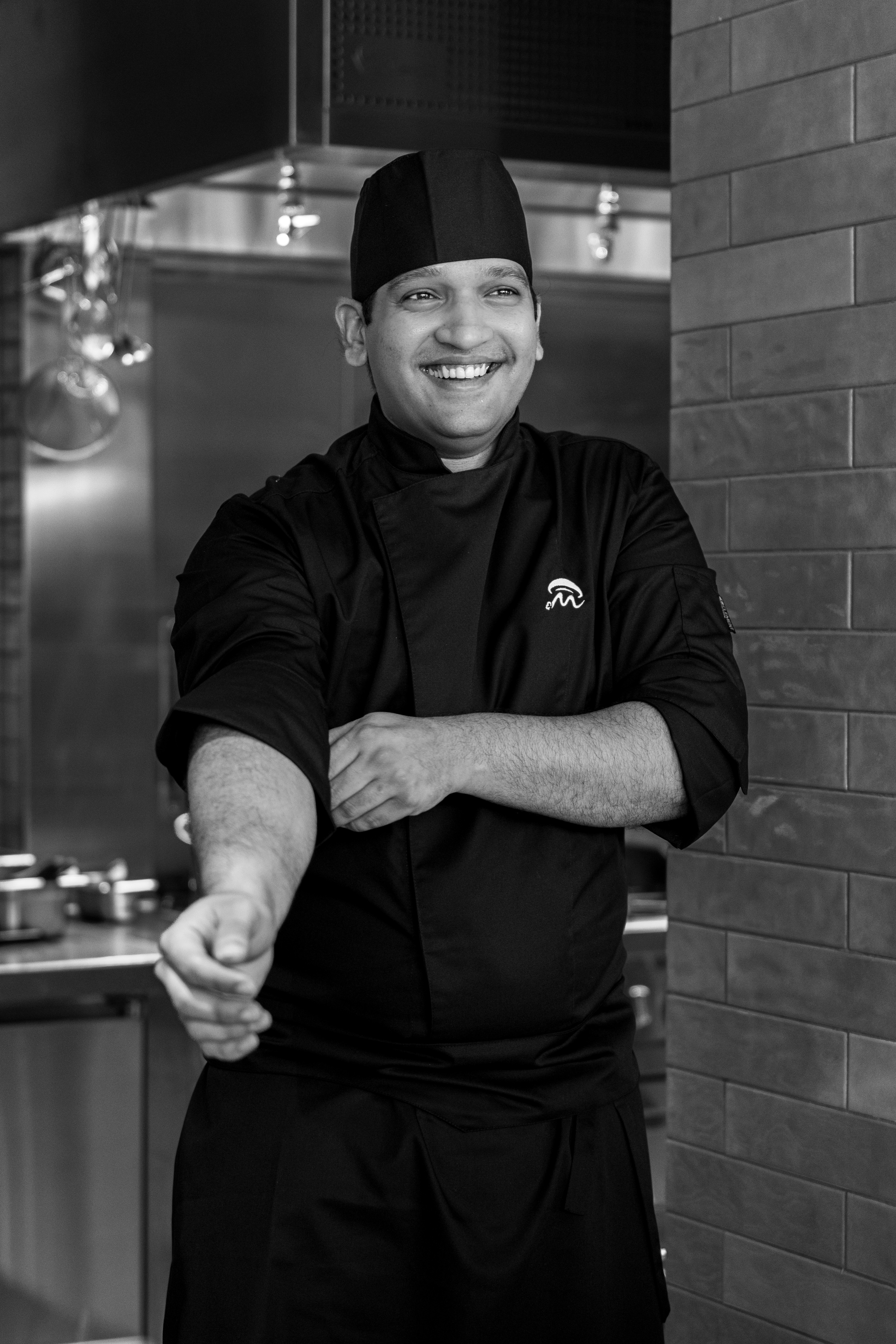 a man in a black chef's uniform