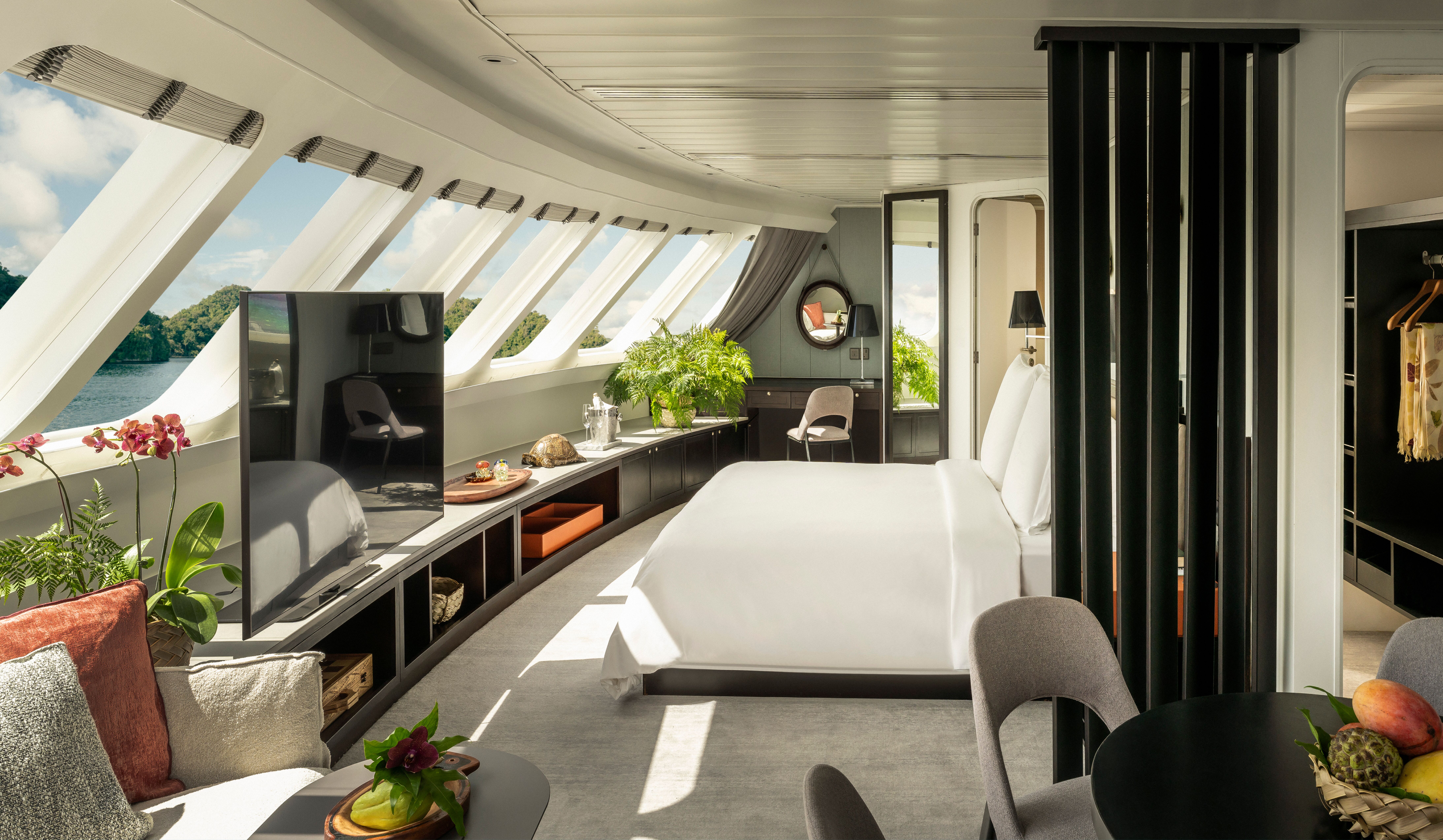 a room with a bed and a television