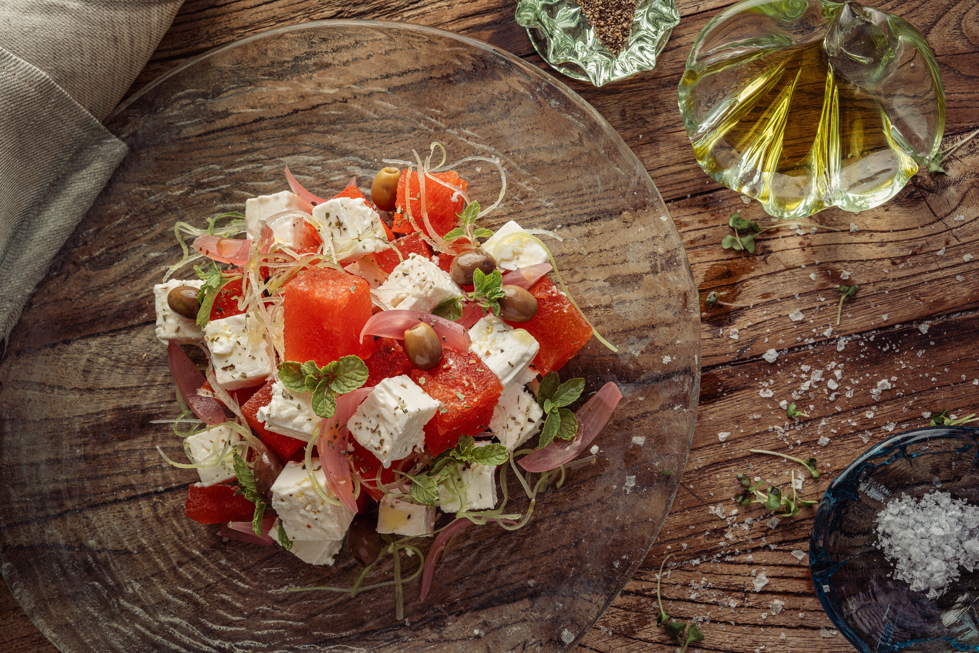 a plate of salad with tomatoes and feta cheese