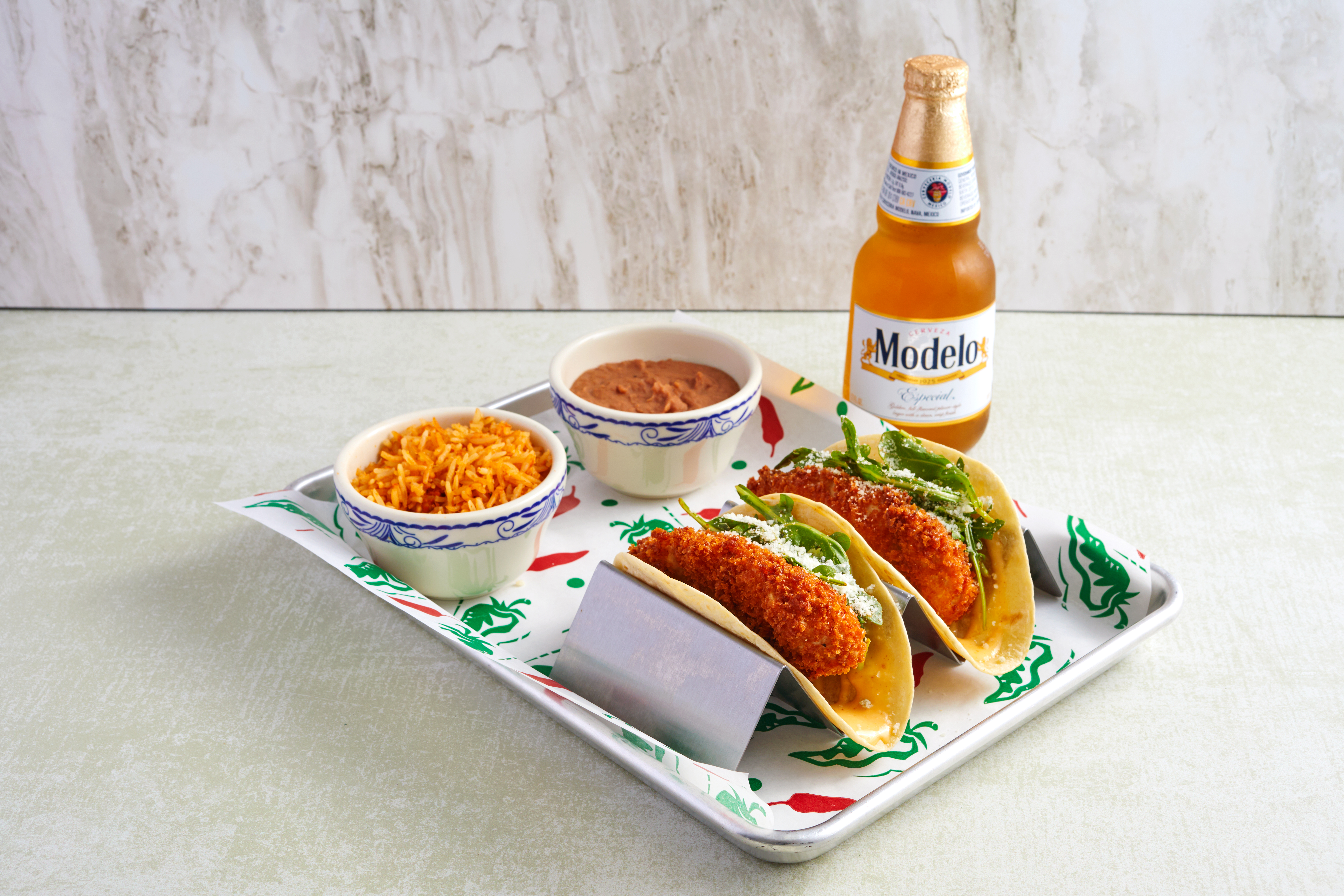 a plate of food and a bottle on a table