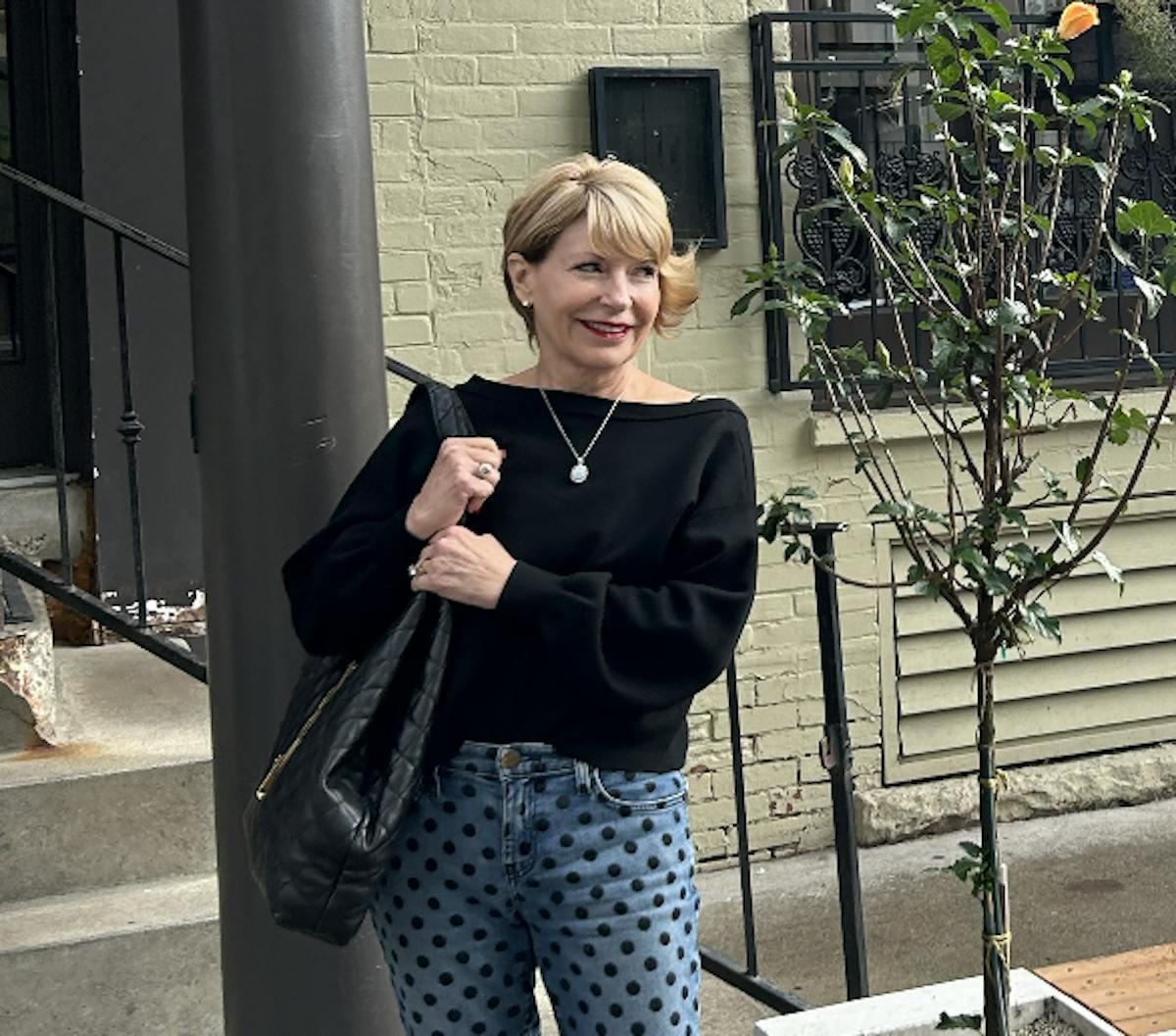 a woman standing in front of a camara