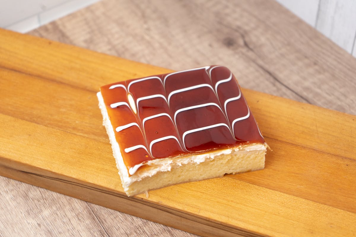 a piece of cake sitting on top of a wooden cutting board