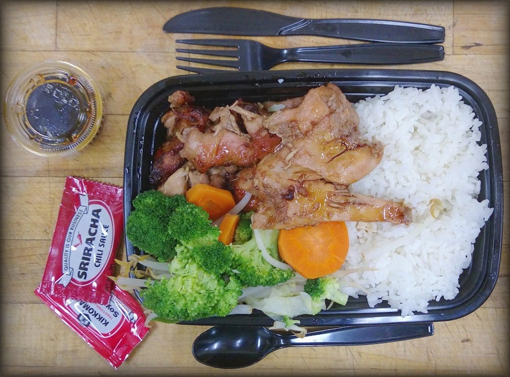 a plate of food with rice meat and vegetables