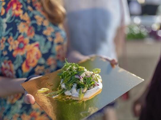 a close up of a person holding a piece of food