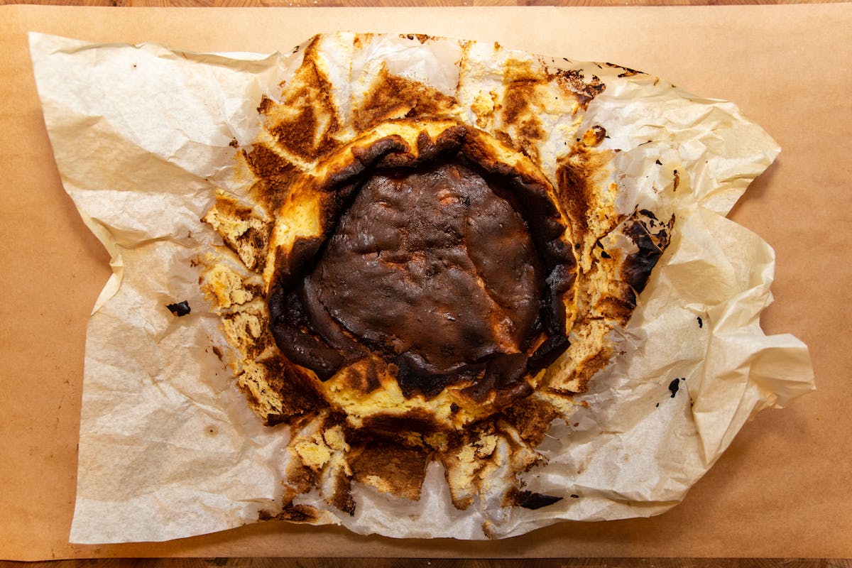 a half eaten cake sitting on top of a piece of paper