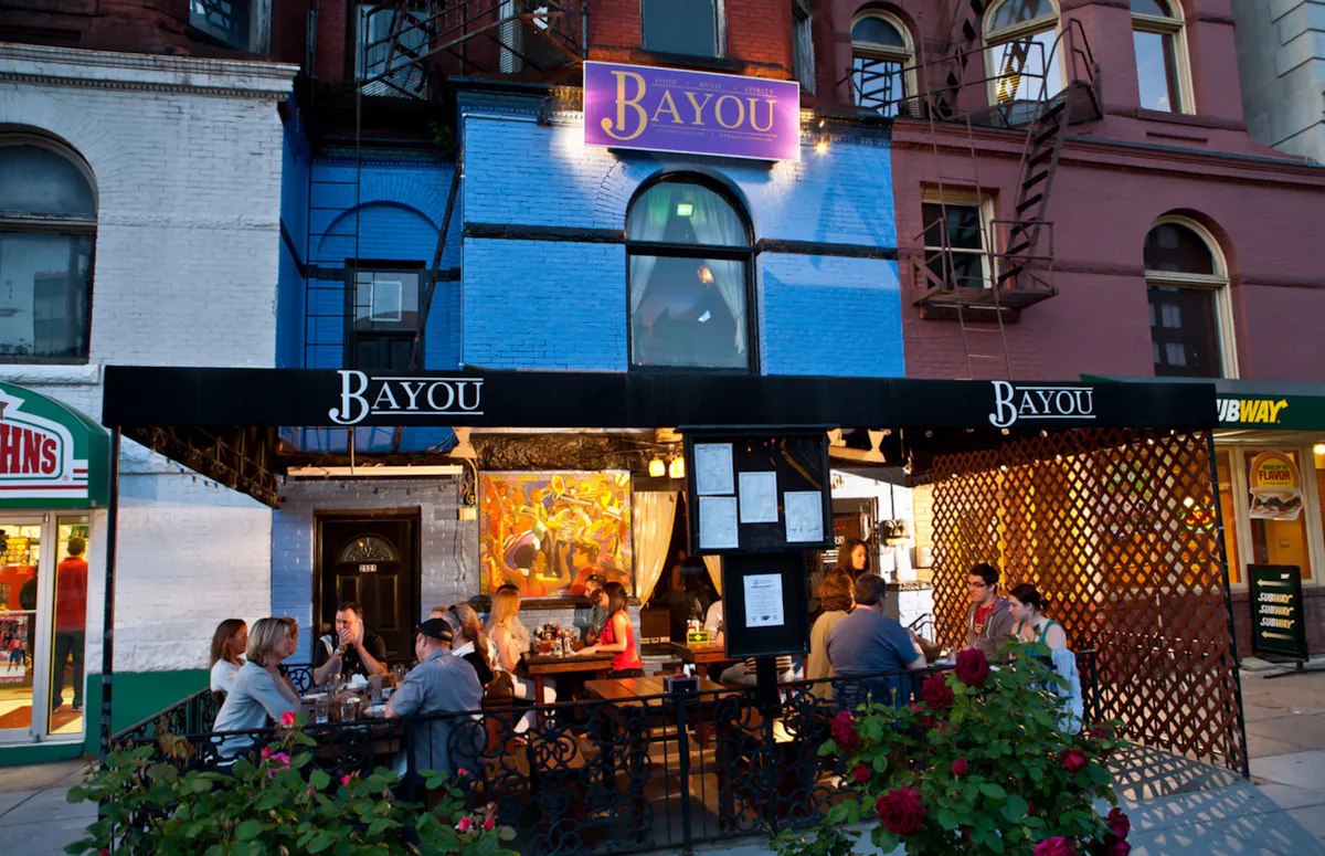 People outside on Bayou's patio in the evening
