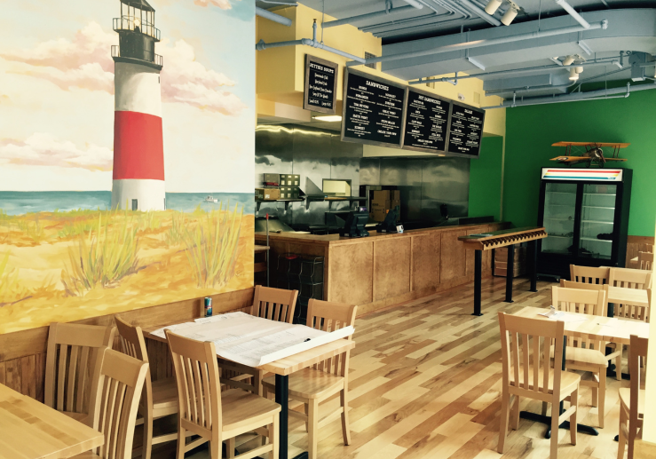 a restaurant with a lighthouse mural on the wall