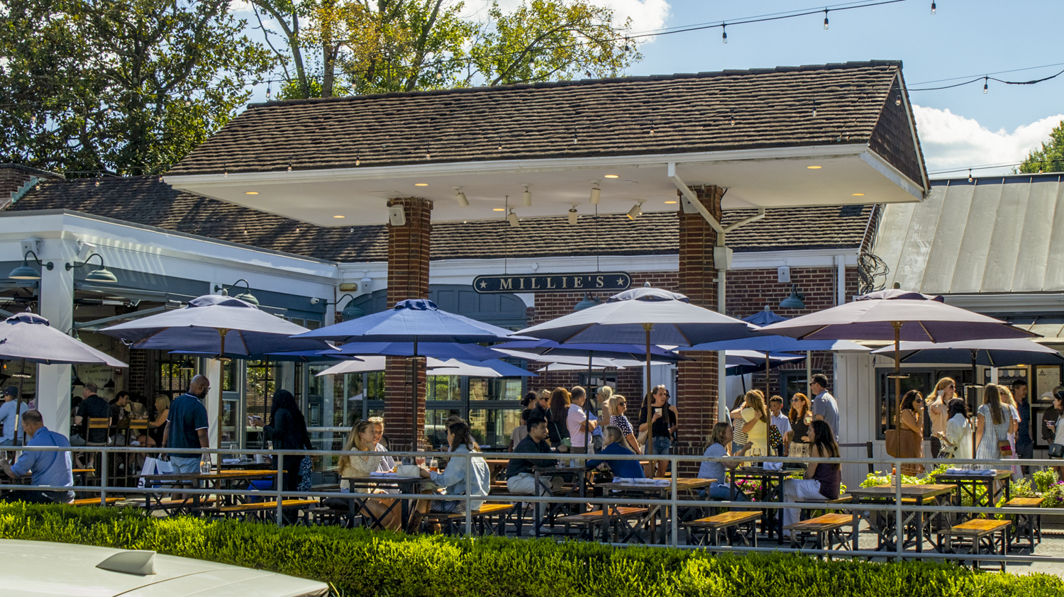 a group of people sitting outside a restaurant