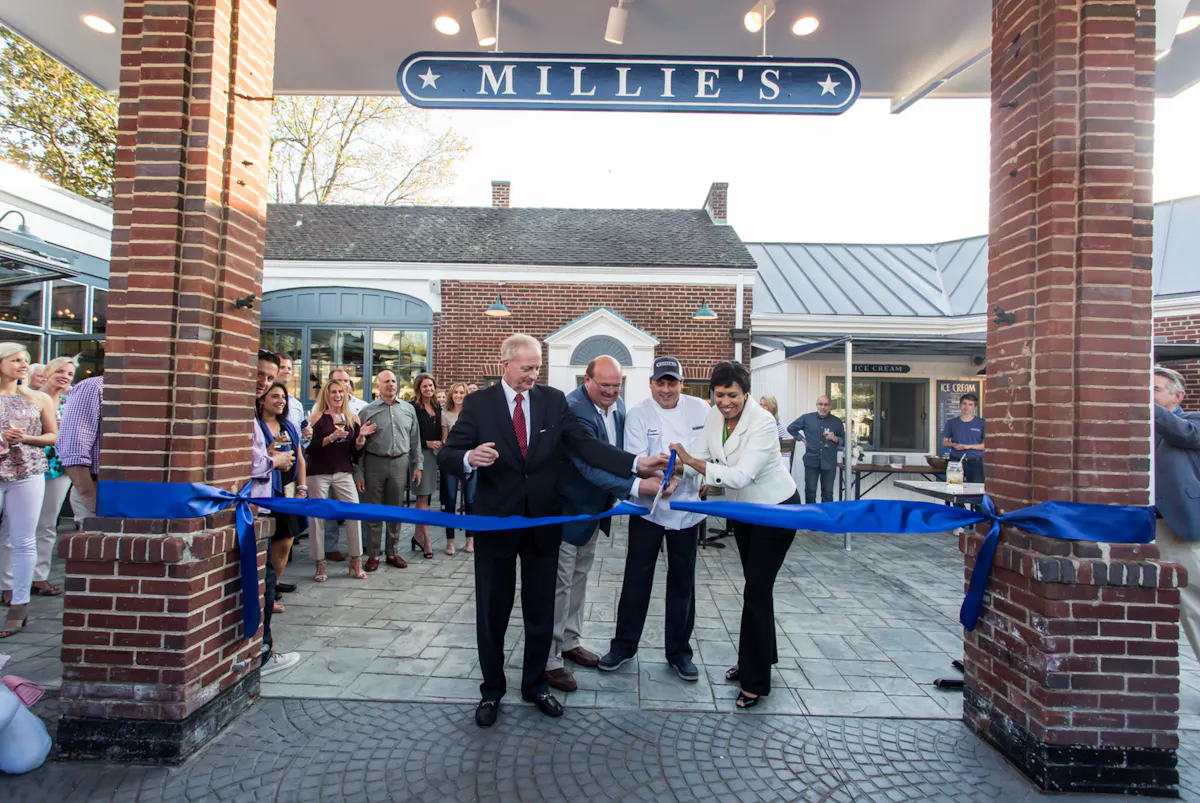 a man and woman cutting a ribbon