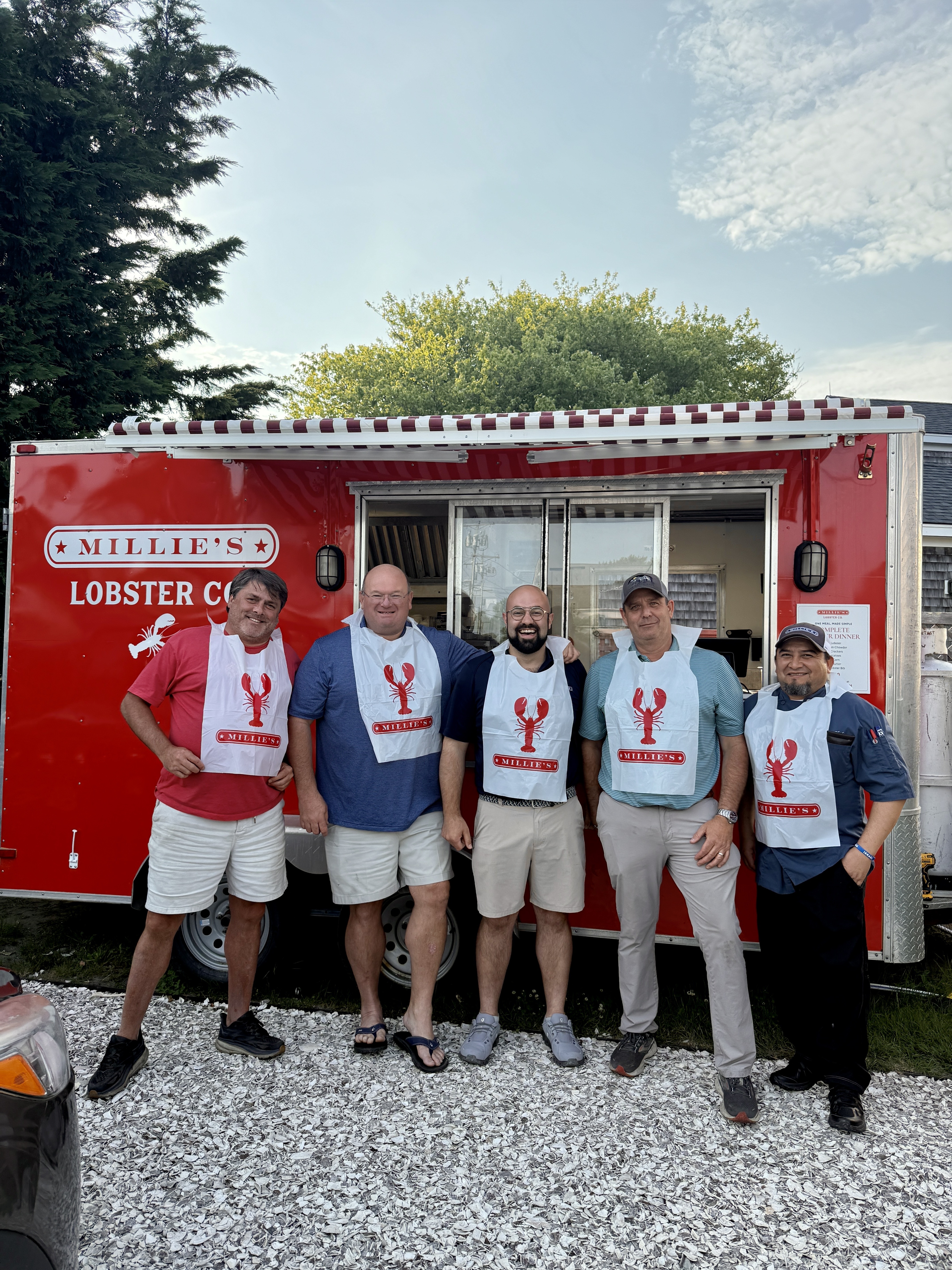 group of men in front of a red building