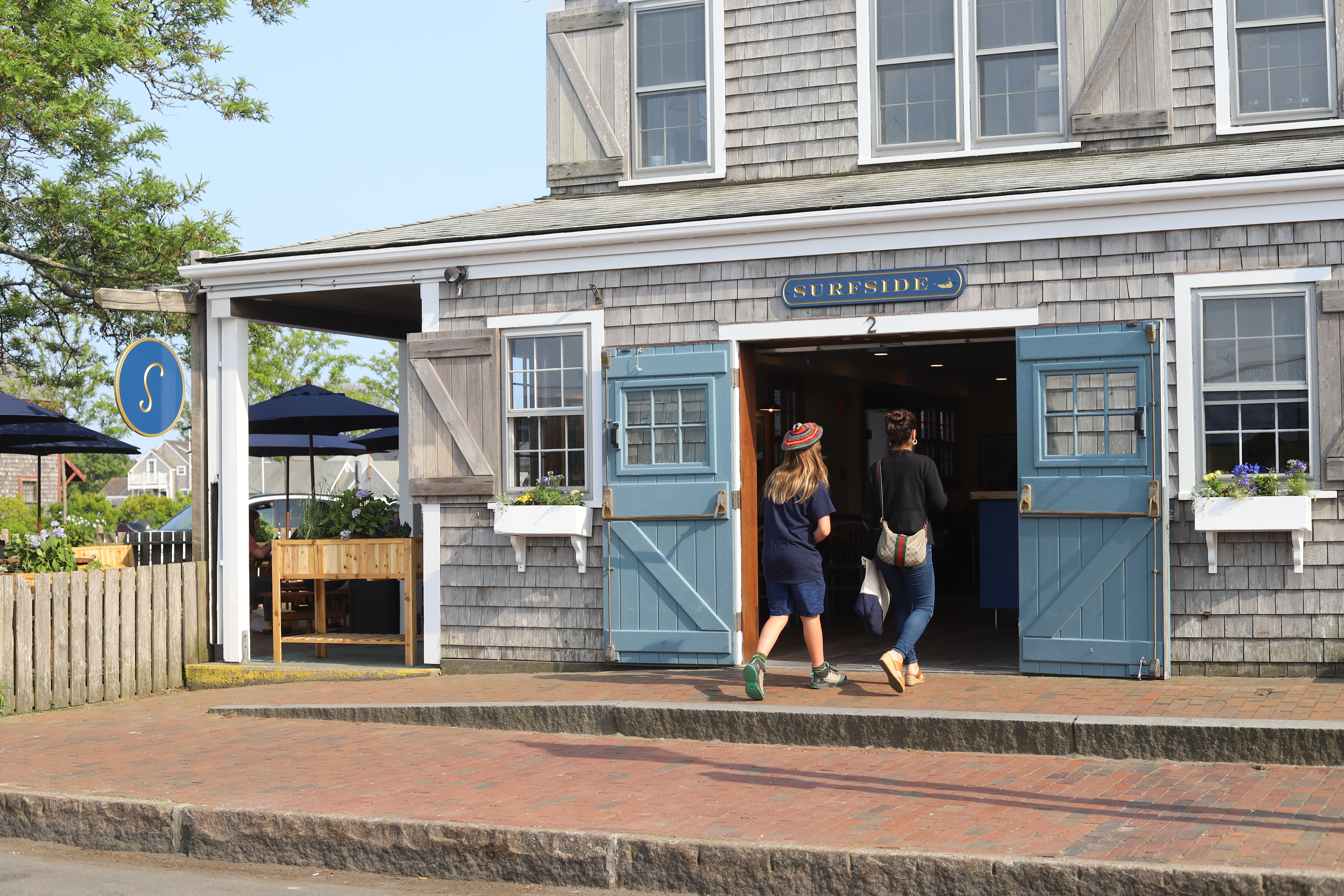 a person standing in front of a brick building