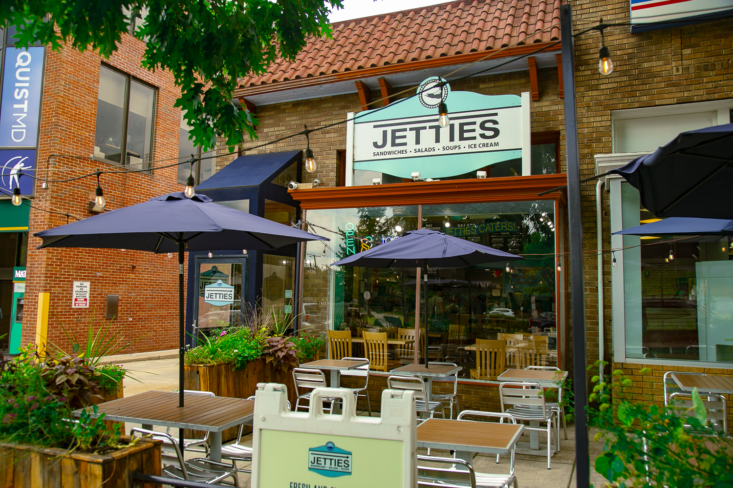 Exterior of Jetties Chevy Chase with patio and chairs