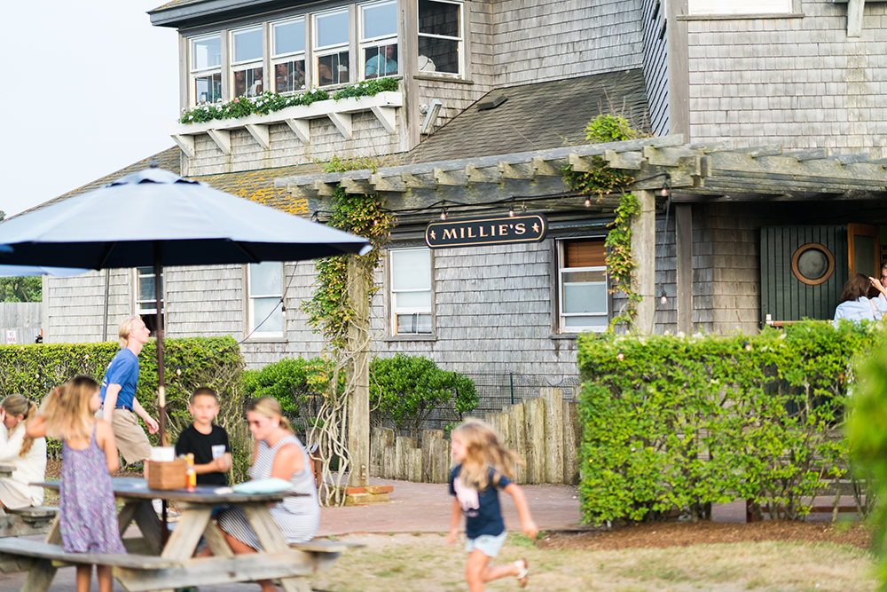 a group of people sitting in front of a house