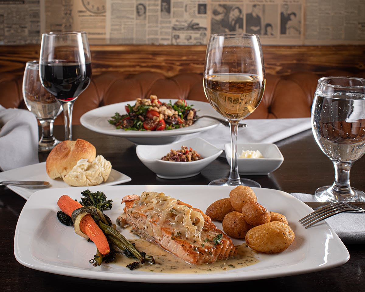 a plate of food and a glass of wine