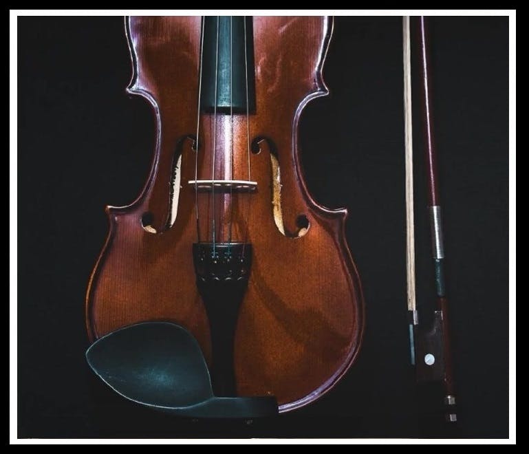 a violin sitting on top of a instrument