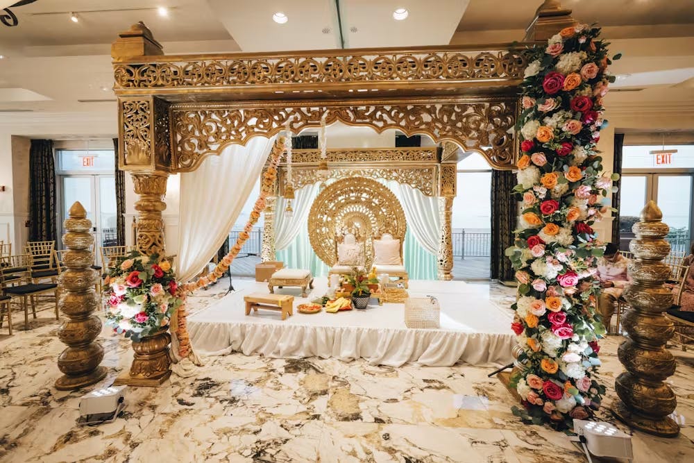 a room filled with furniture and vase of flowers on a table