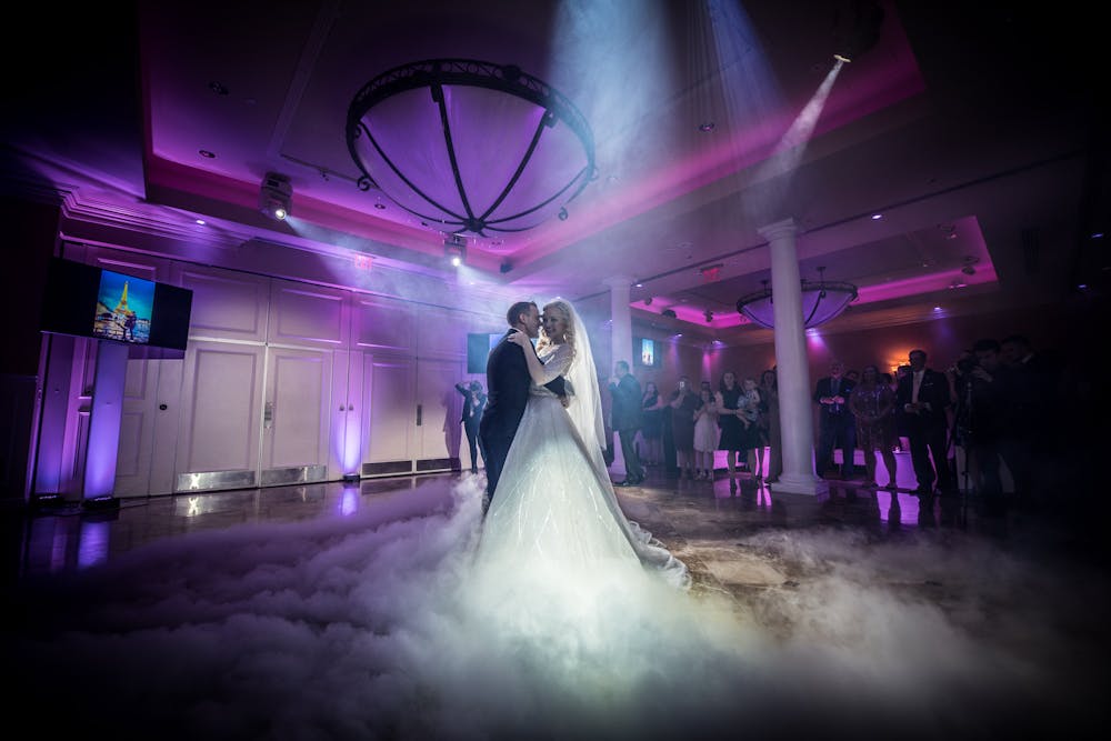 a train on a track with smoke coming out of the stage