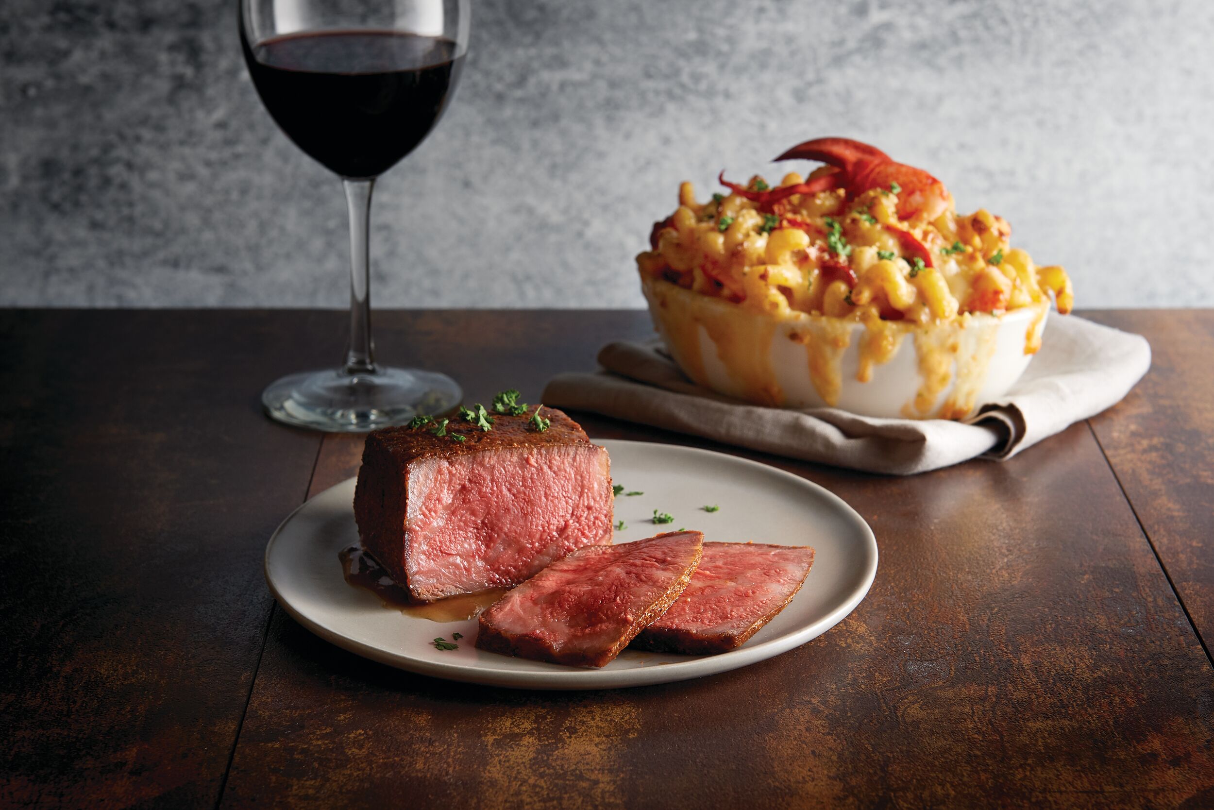 a plate of food and a glass of wine