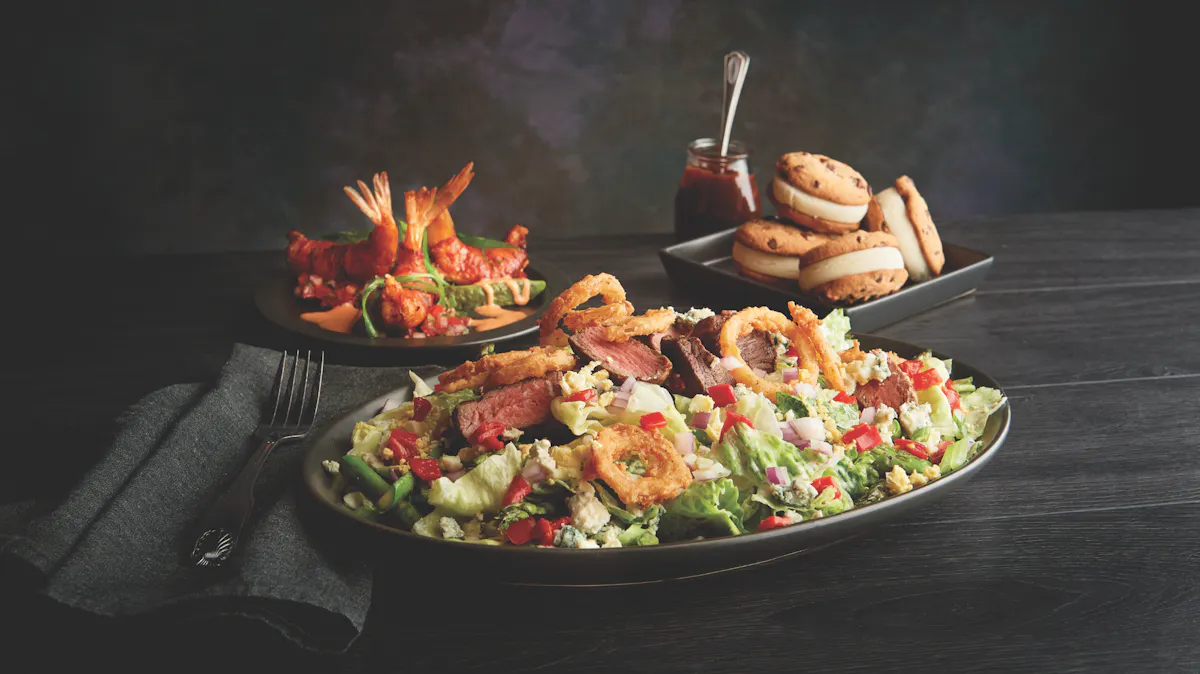 three plates on a table, a salad plate, a shrimp plate, and cookies