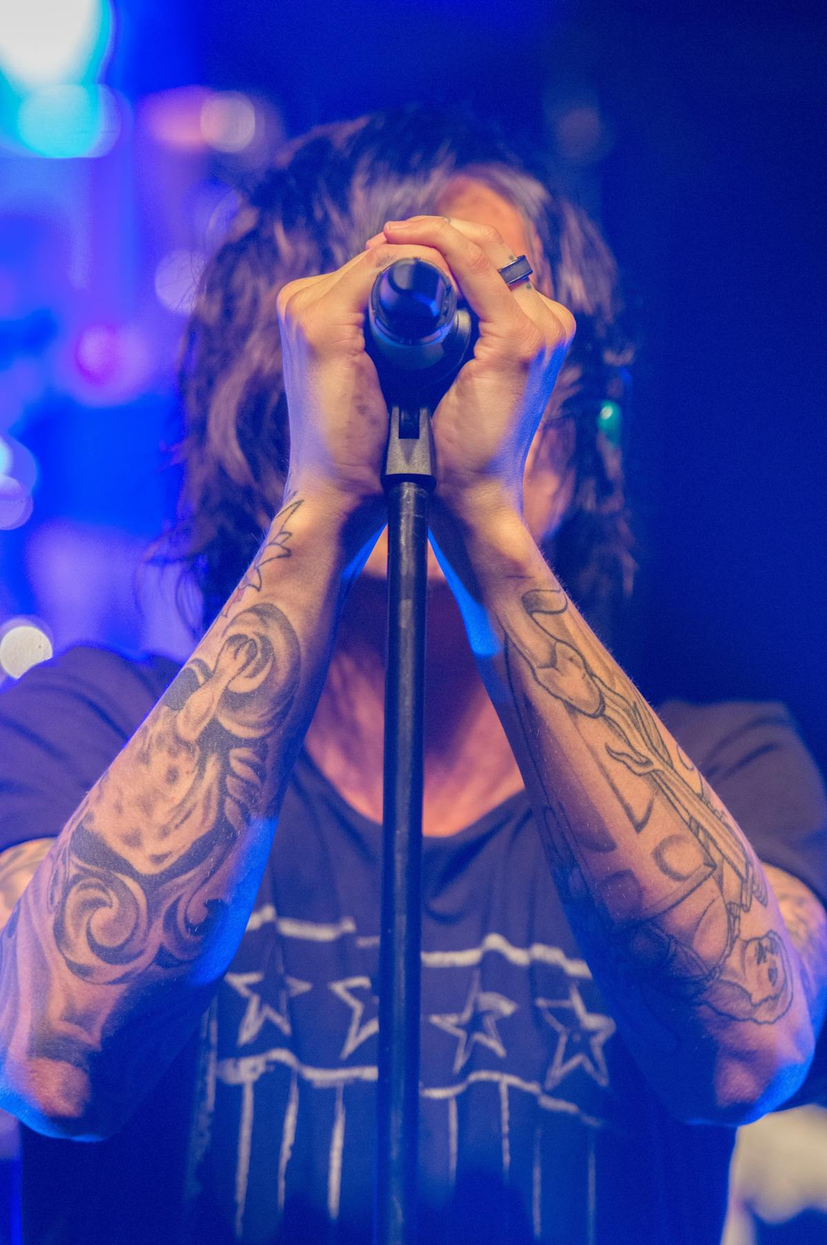 a person holding a tattoo on a stage