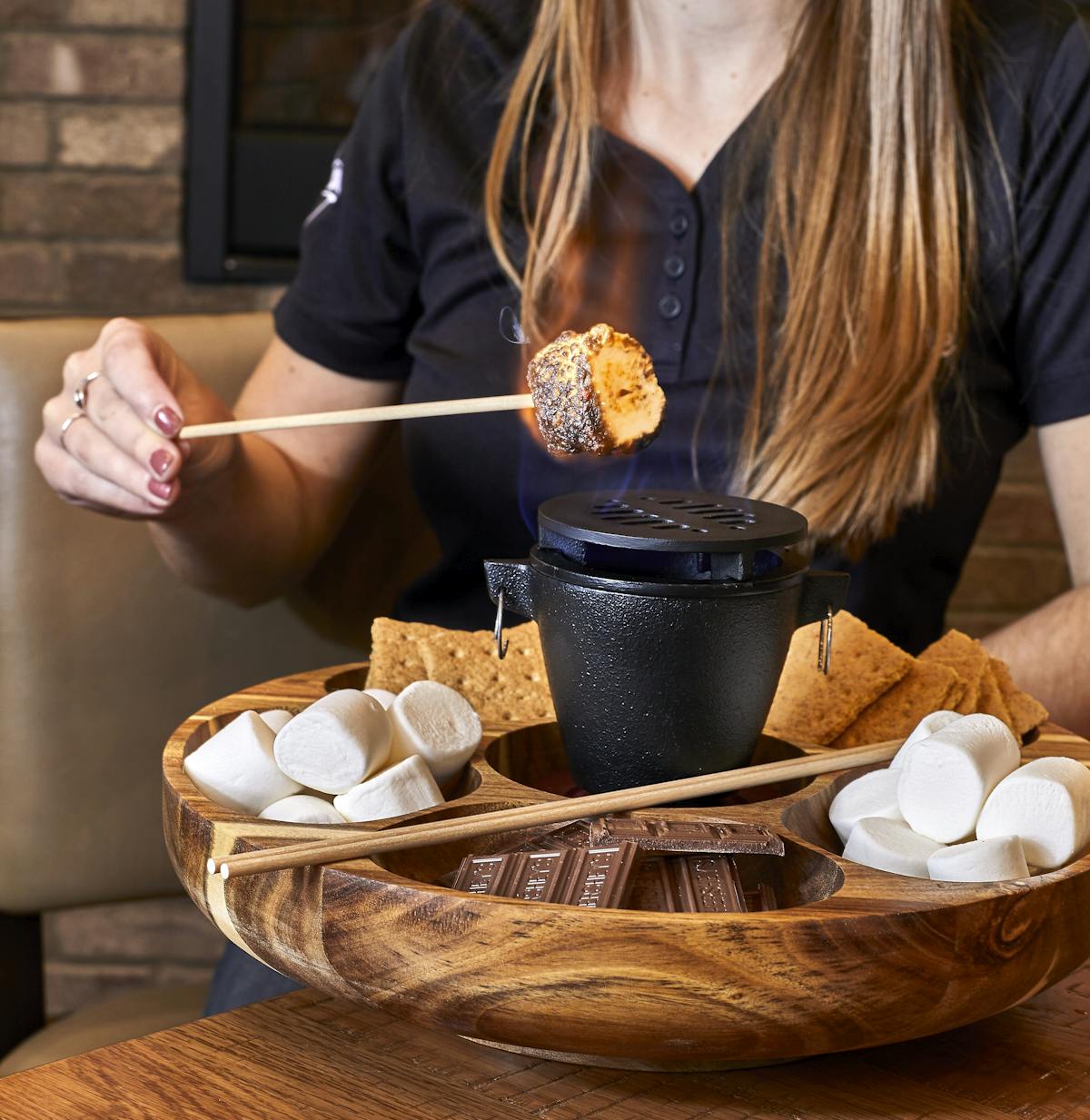 a woman sitting at a table with a bowl of food