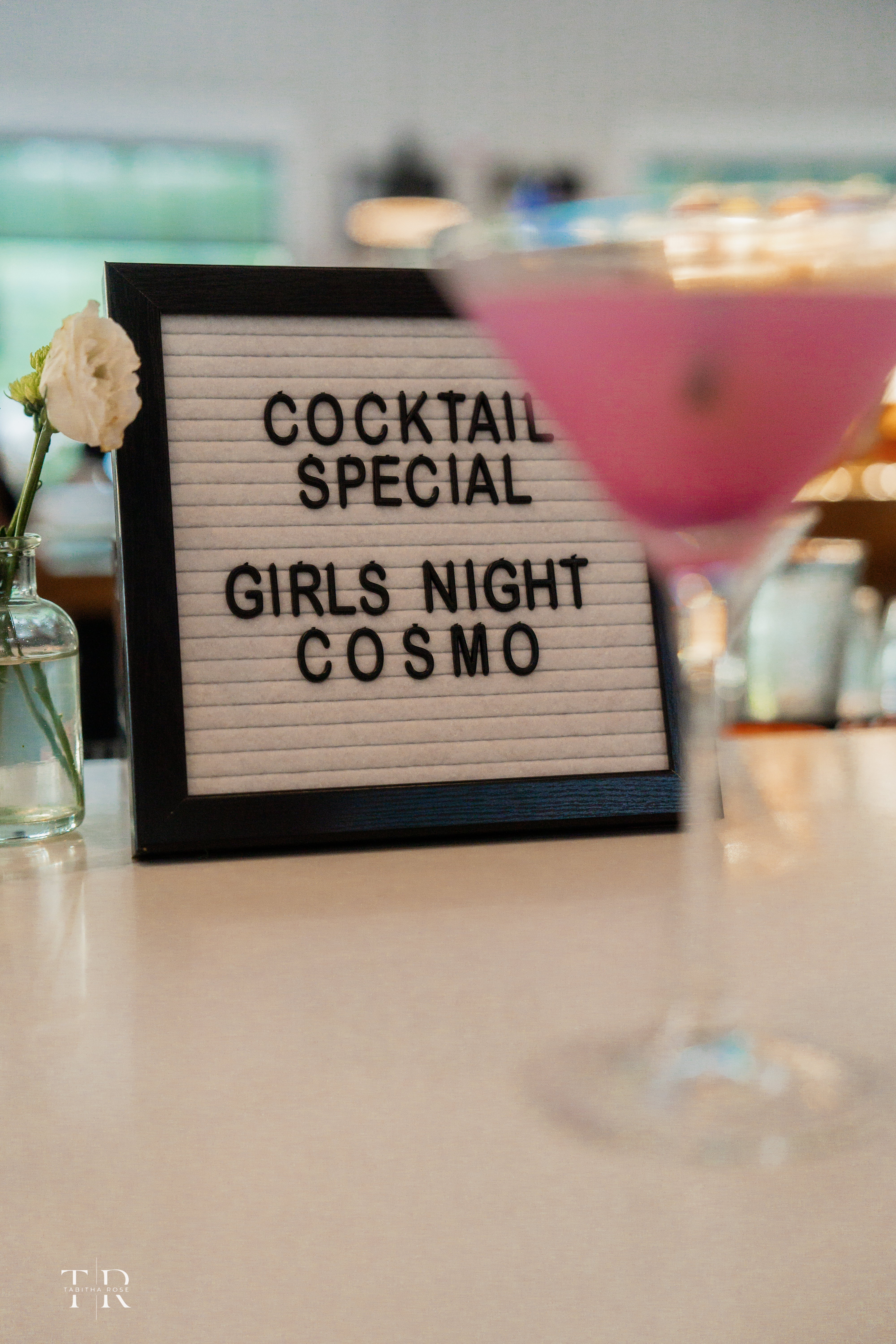 a glass of wine sitting on top of a table