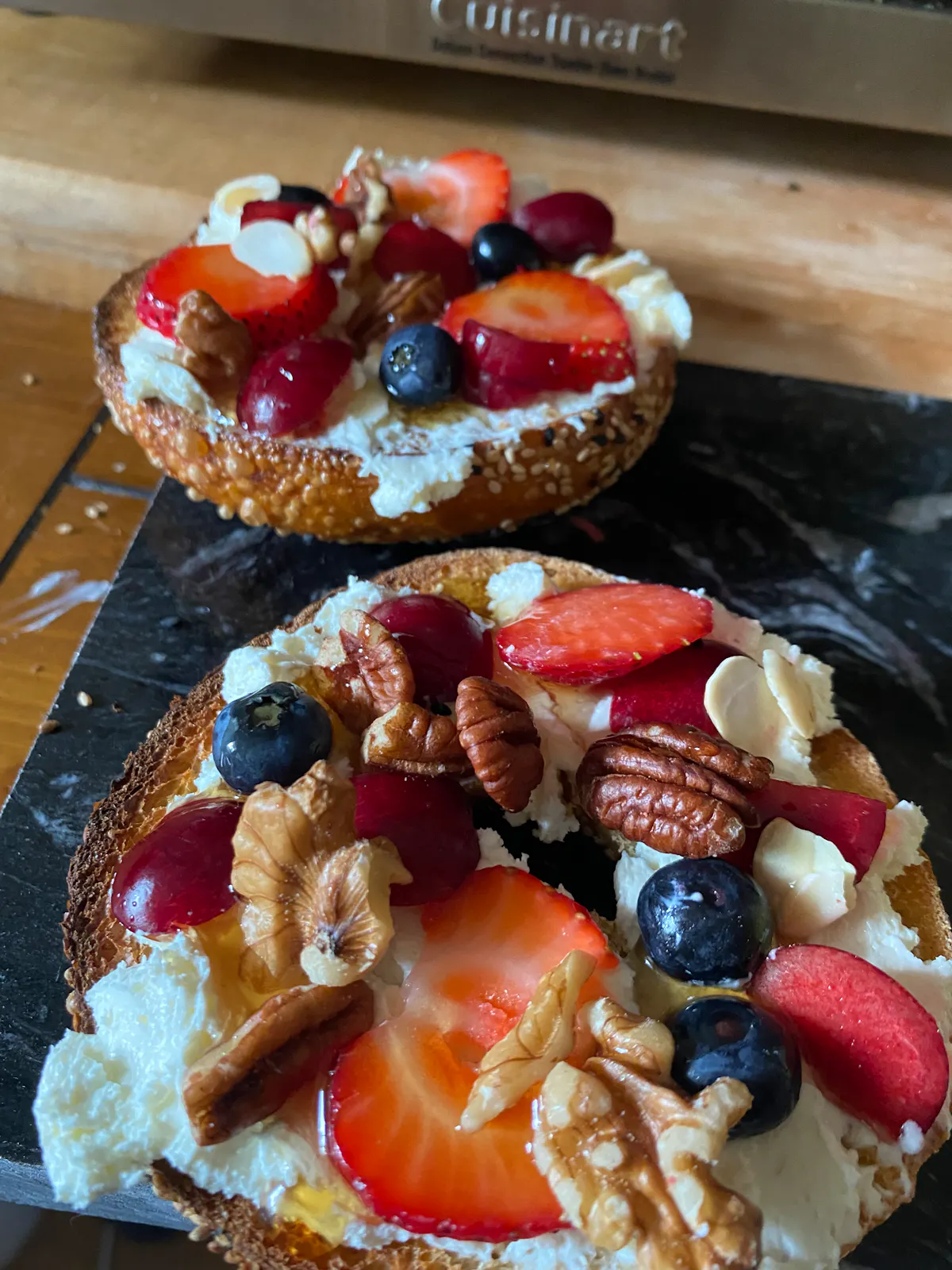 Bagel-ish bagel with fresh berries, walnuts, pecans, cream cheese, and maple syrup