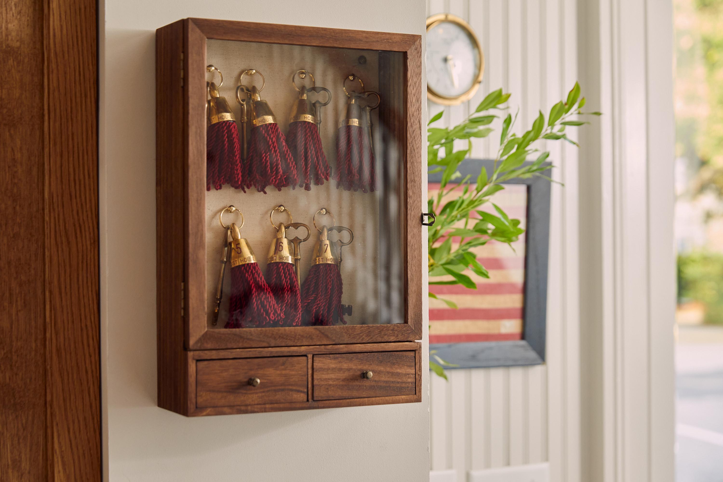 a wooden box with tassels in it